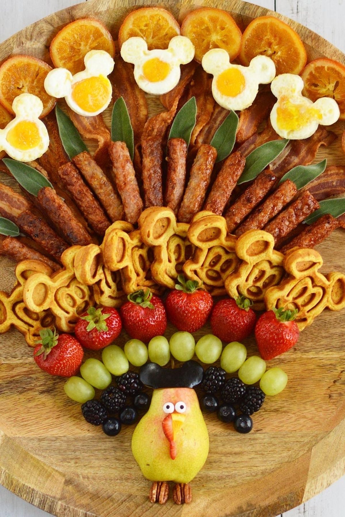 A delicious Turkey Charcuterie Board made with applewood bacon, Mickey shaped eggs and pumpkin Mickey waffles.