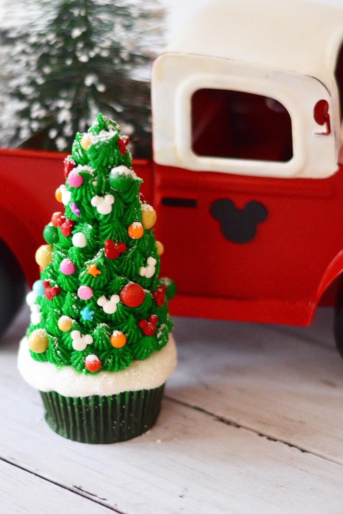 These Christmas tree cupcakes are filled with Disney's Grey Stuff and topped with a beautiful decorated Mickey shaped ice cream cone tree.  