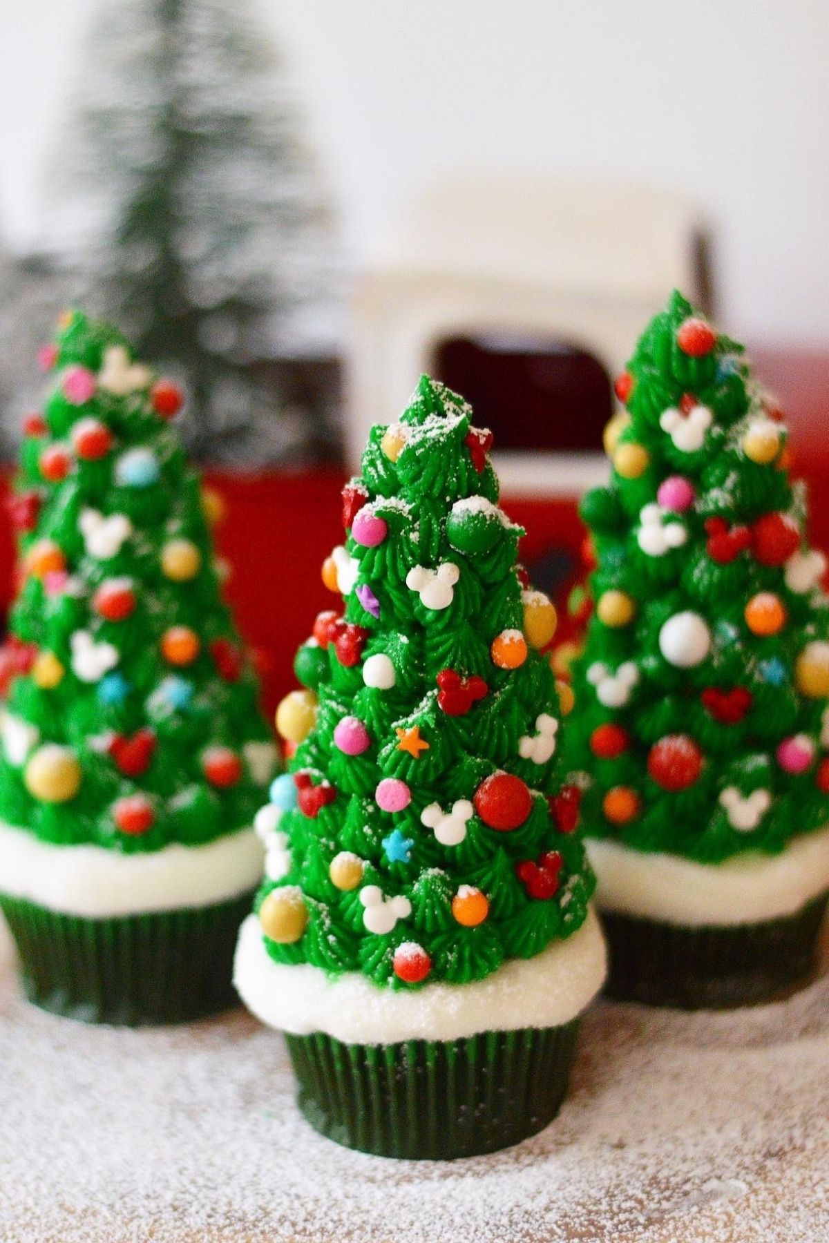 These Christmas tree cupcakes are filled with Disney's Grey Stuff and topped with a beautiful decorated Mickey shaped ice cream cone tree.  