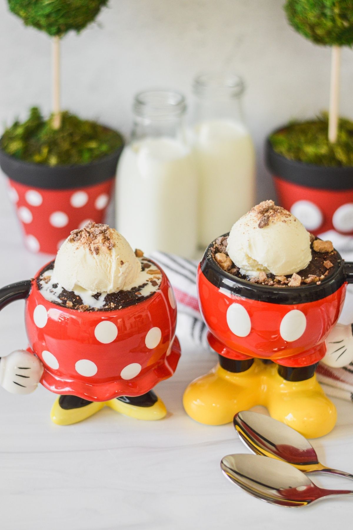 Mickey and Minnie mugs filled with a fudgy mug brownie and topped off with vanilla ice cream and crushed Heath Bar.