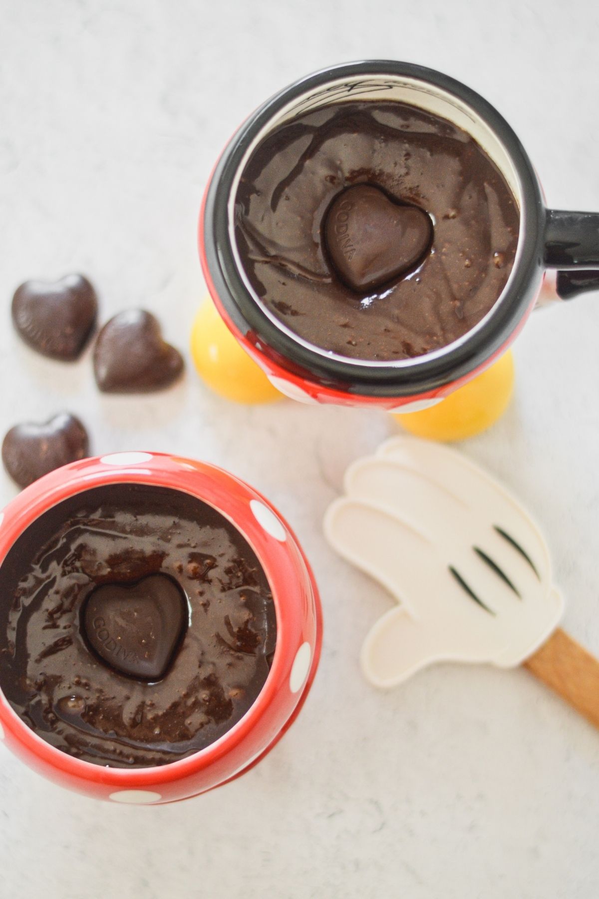Fudgy mug brownie inside Mickey and MInnie mugs.  Godiva chocolate truffle center.