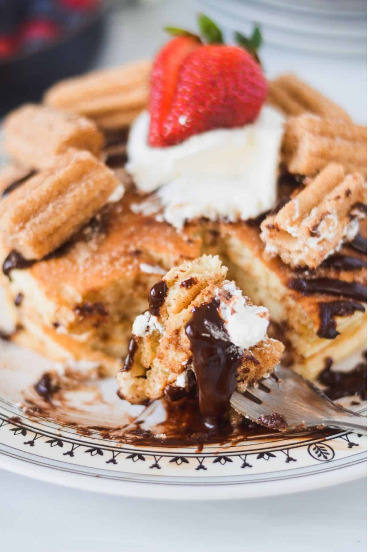 Churro pancakes drizzled with warm cinnamon chocolate sauce.