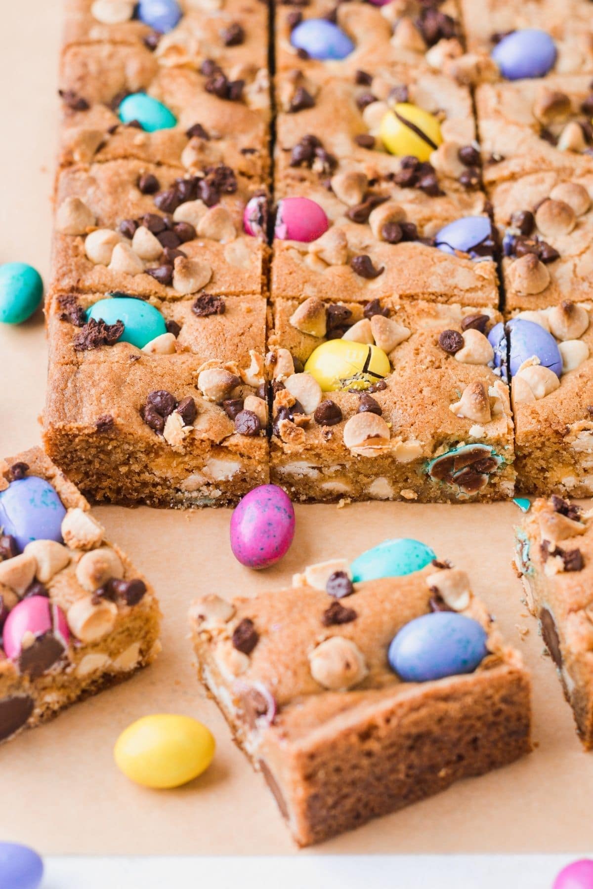 Mini egg cookie bars sliced into squares and decorated with M&M chocolate eggs.  