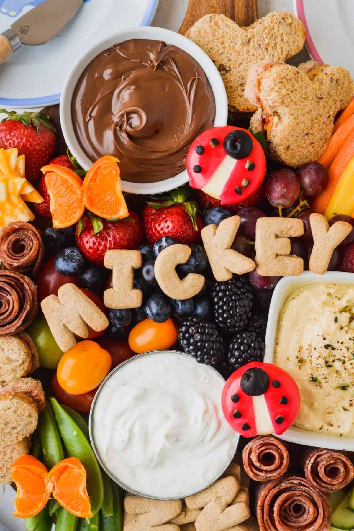 Ranch and hummus with a variety of fruits and veggies.