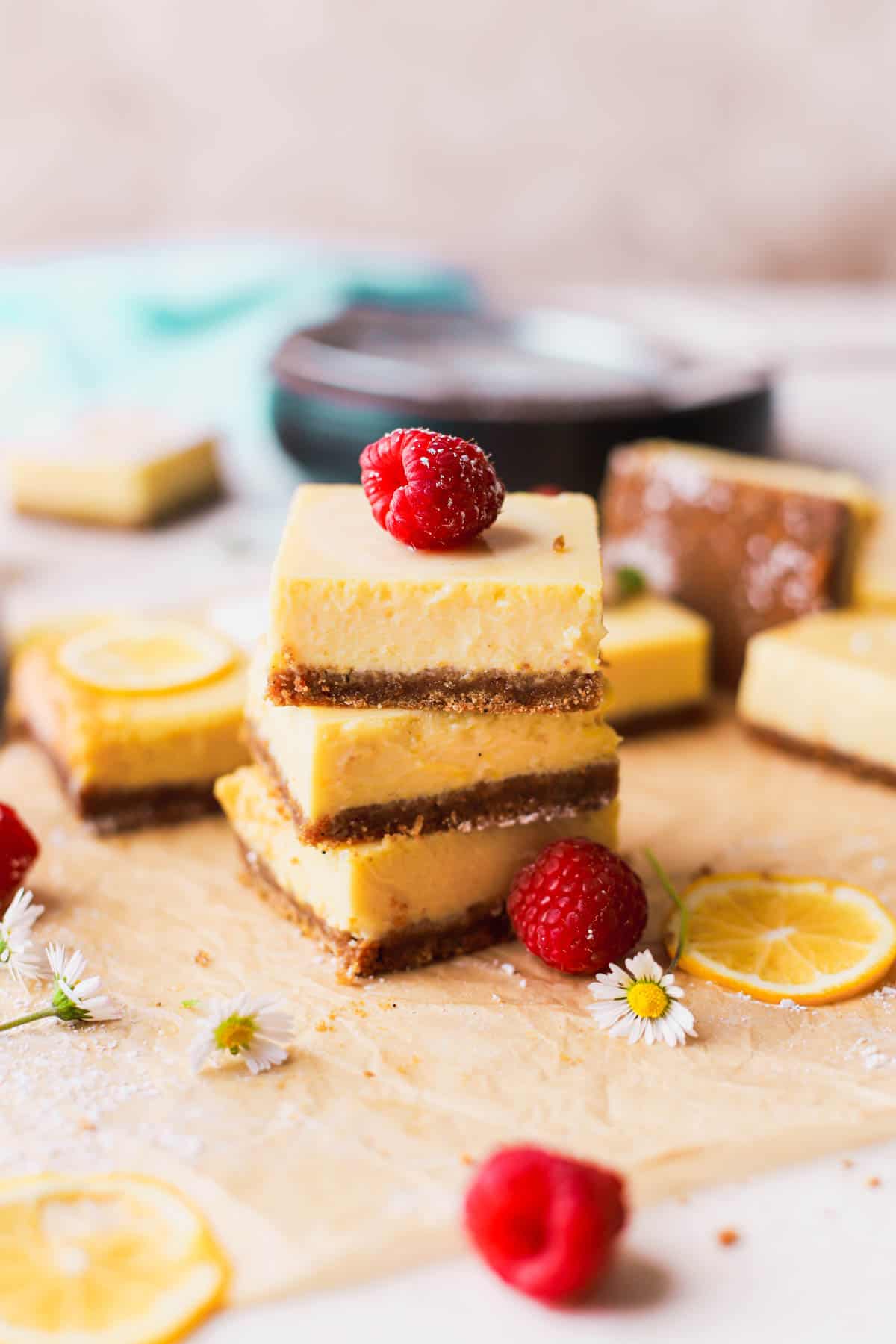 Sliced lemon bars, topped with fresh raspberries.