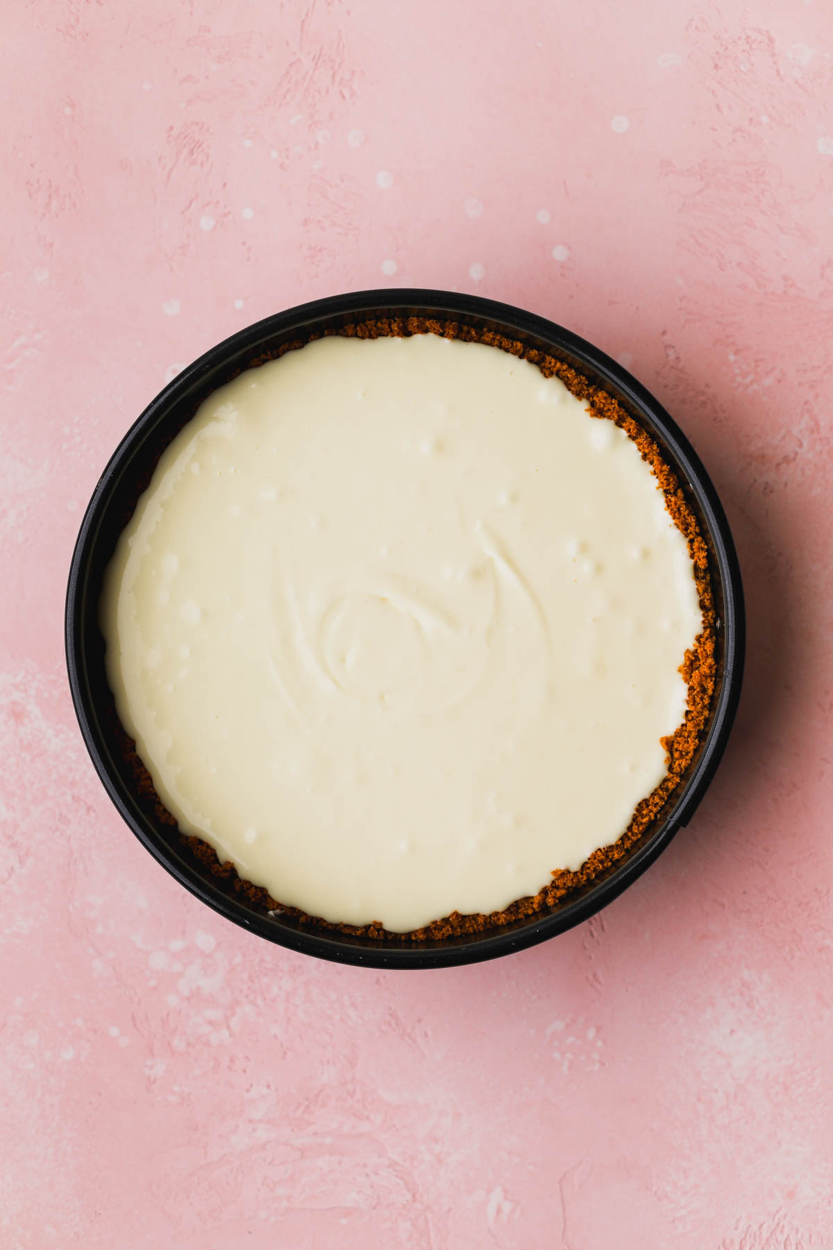 White chocolate cheesecake fillings inside a baked graham cracker crust.  