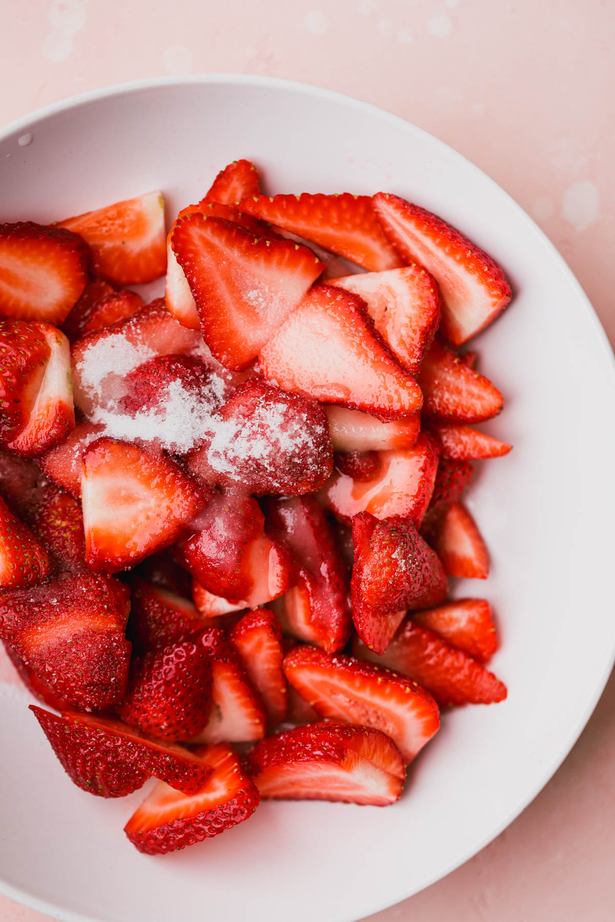 Sliced strawberries, macerating with sugar and lemon juice.