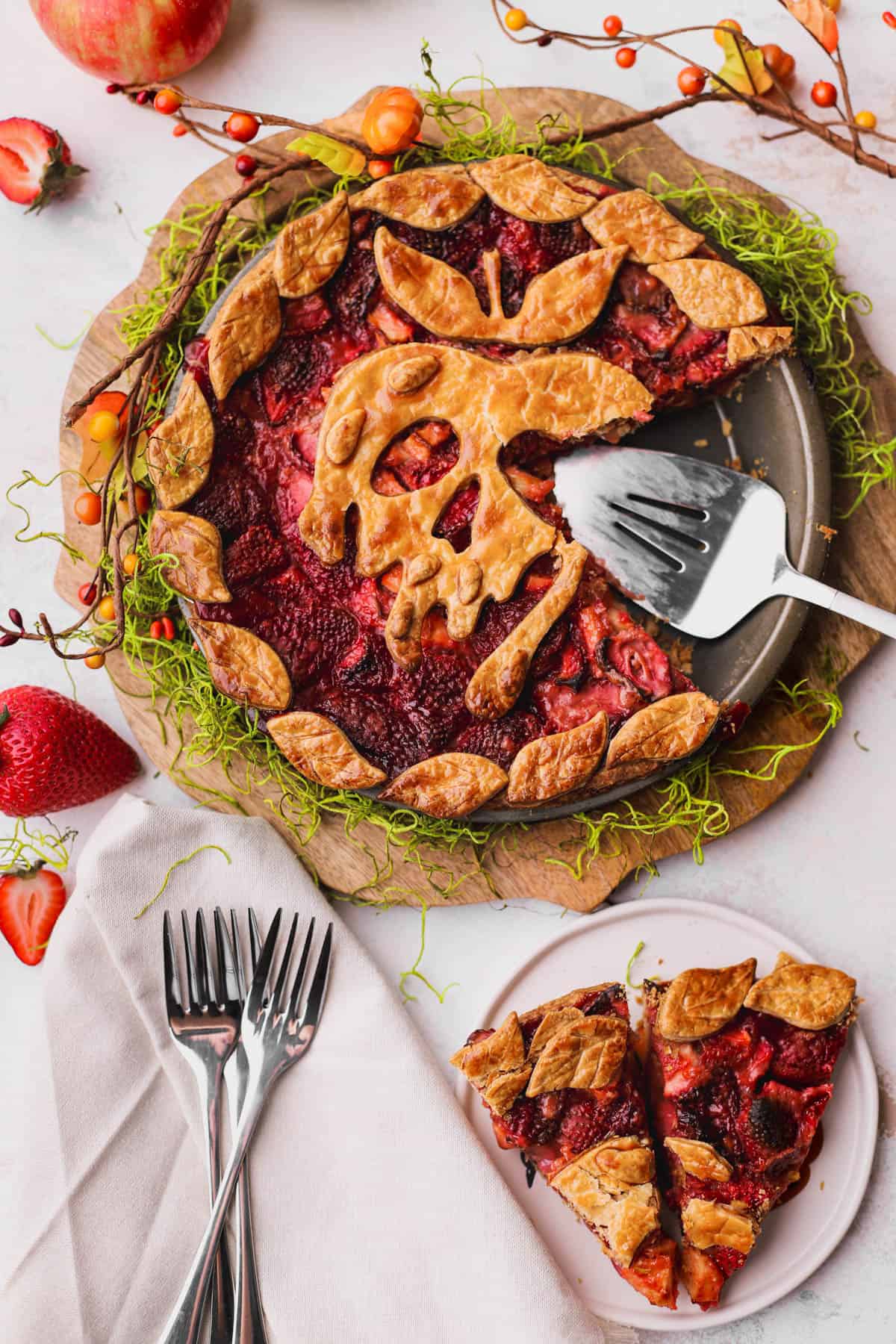 Sliced strawberry apple pie. Fresh strawberries, apples, and Poison Apple decorative crust.