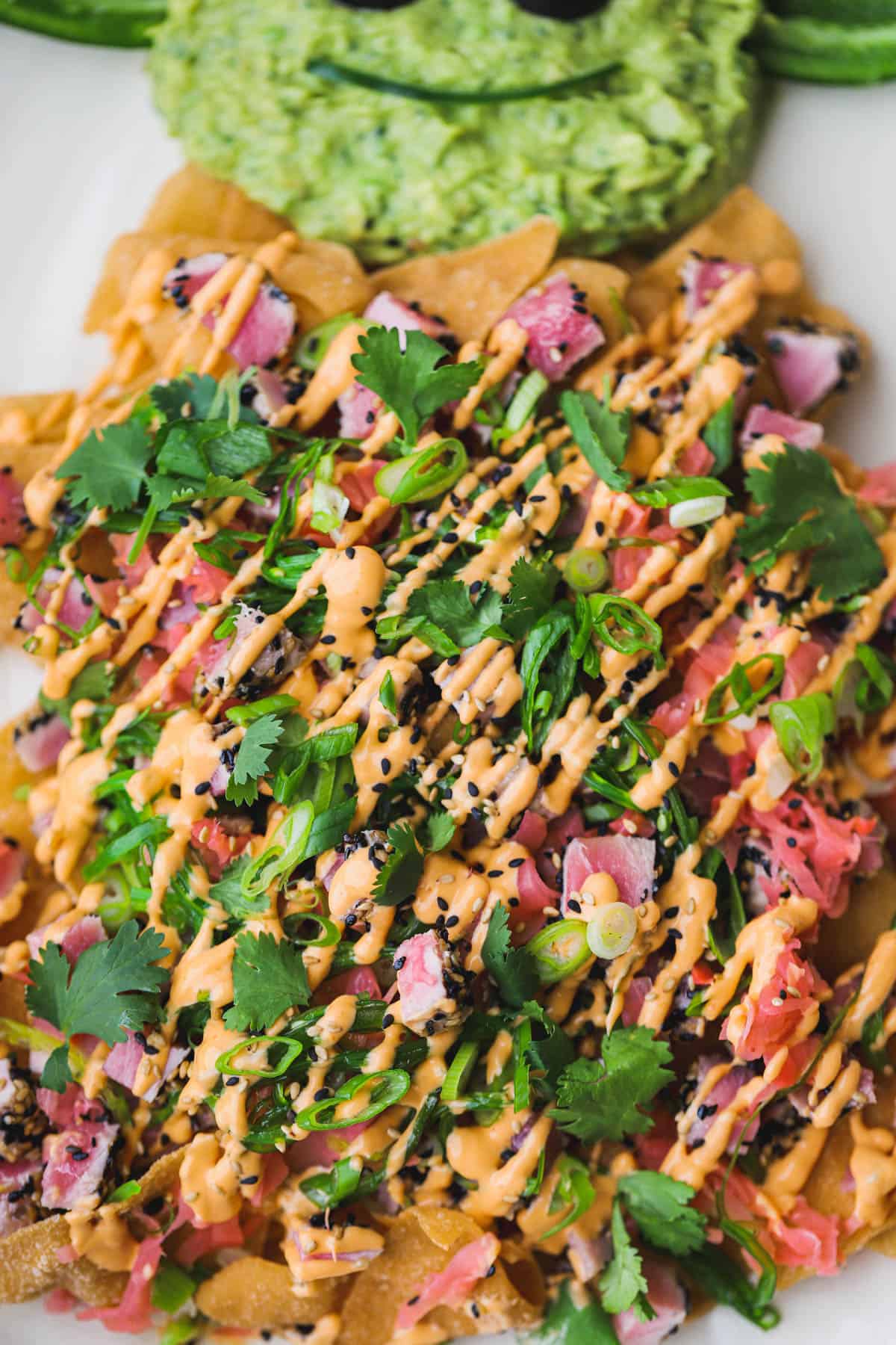 Wonton nachos topped with sesame crusted ahi tuna, spicy mayo, cilantro, pickled ginger and scallions.  Served with Grogu guacamole.  