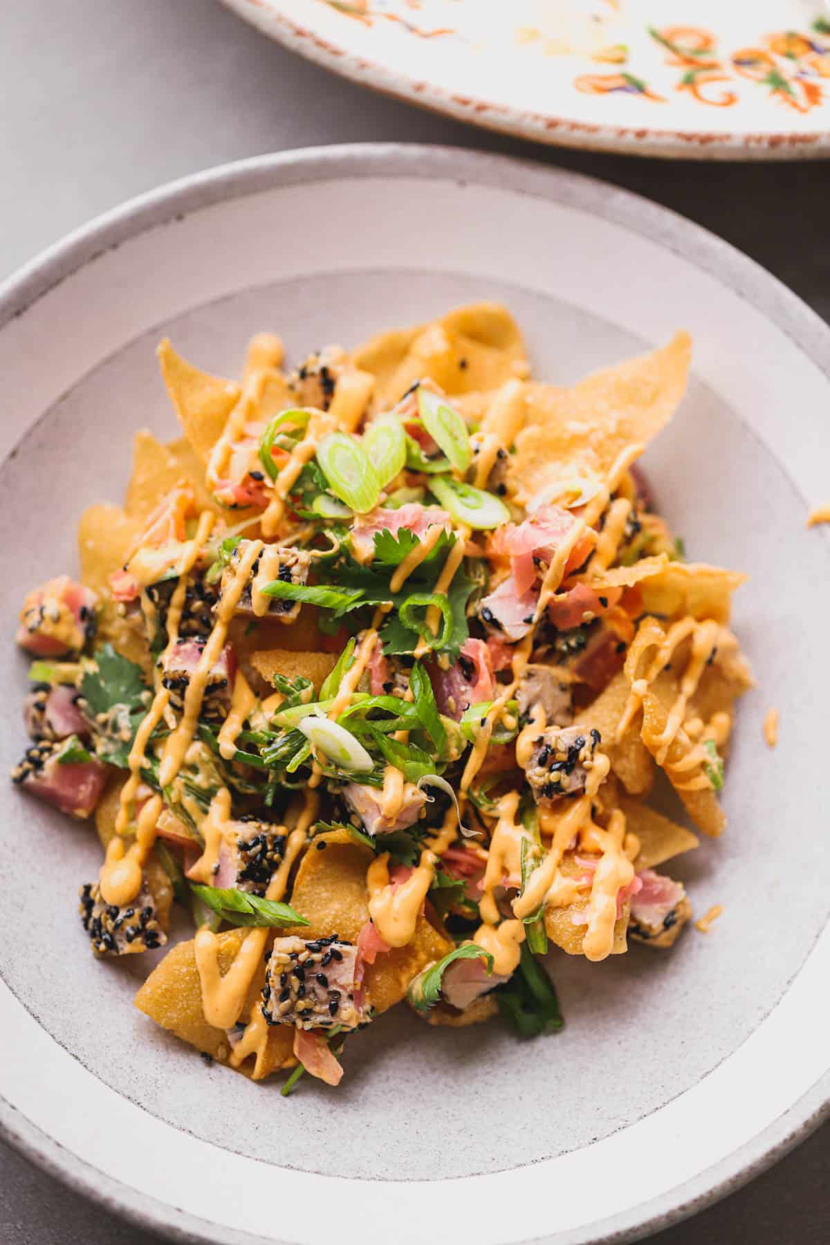 Crisp wontons topped with seared tuna, pickled ginger, spicy mayo, cilantro and scallions.  