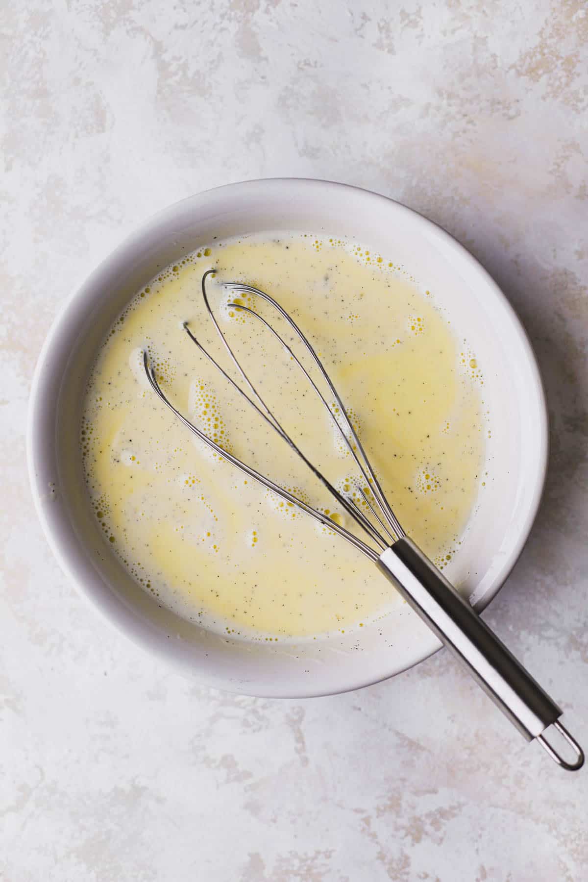 Egg yolks and sugar combined with half and half, vanilla bean and cinnamon sticks.