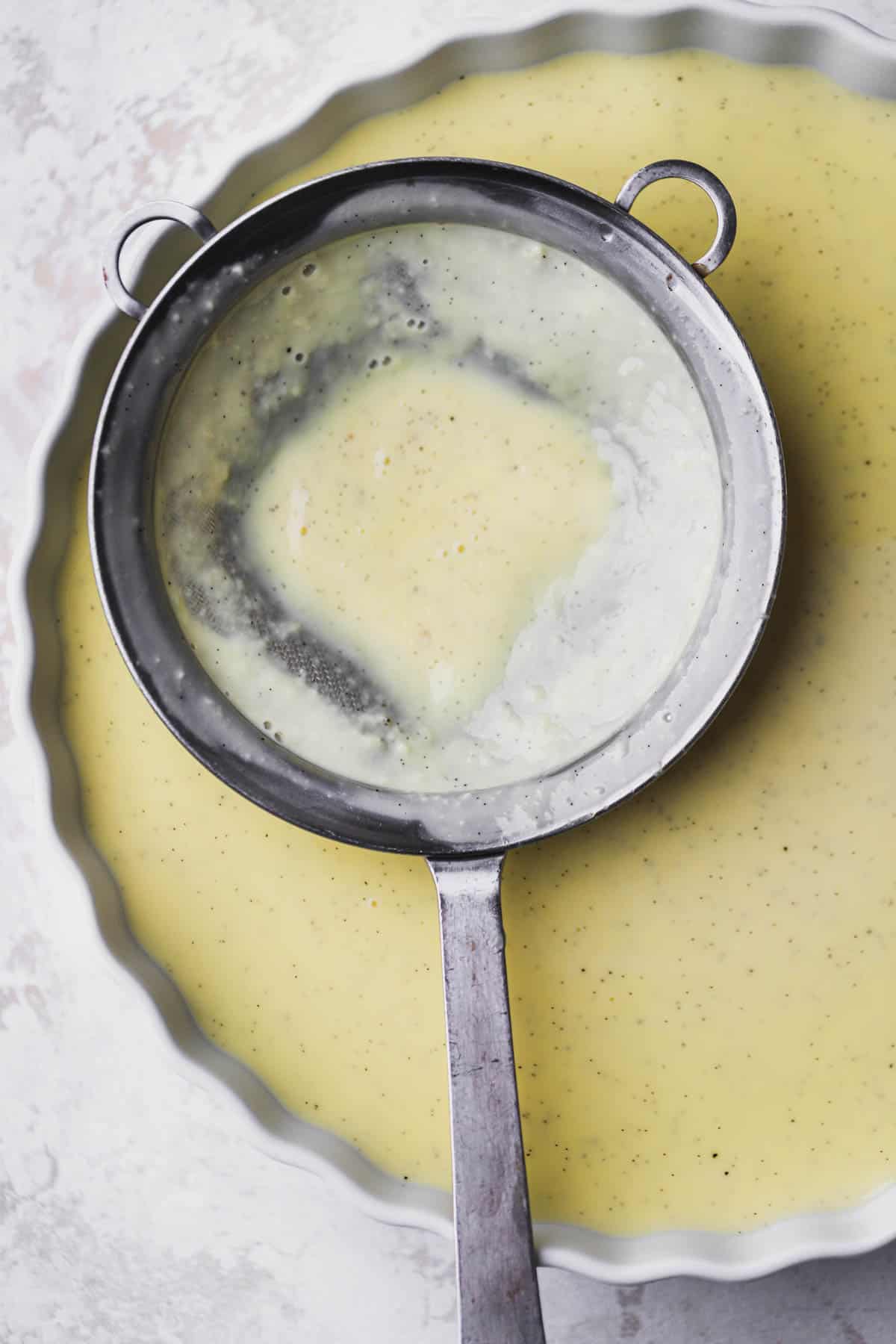 Strained vanilla bean custard.