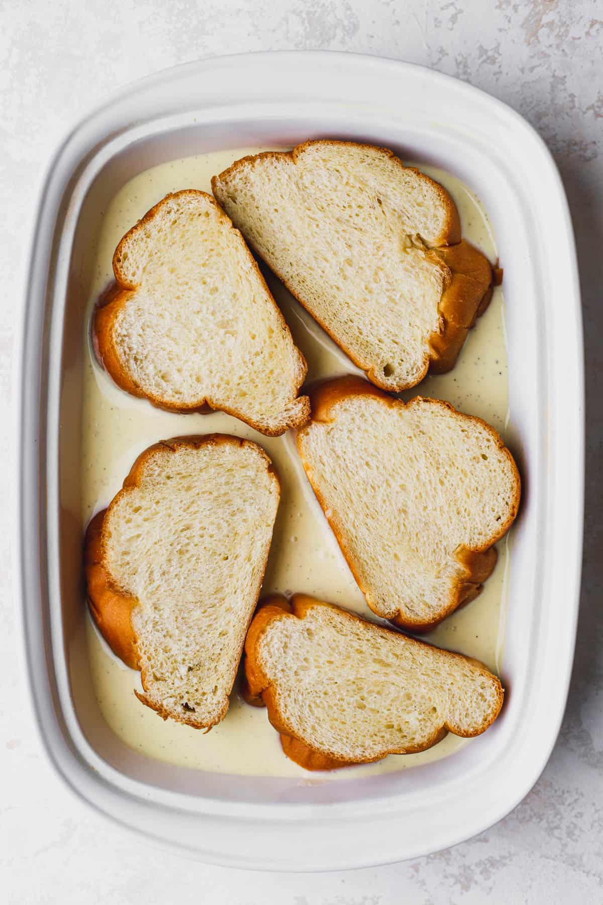Sliced challah dipped in custard.