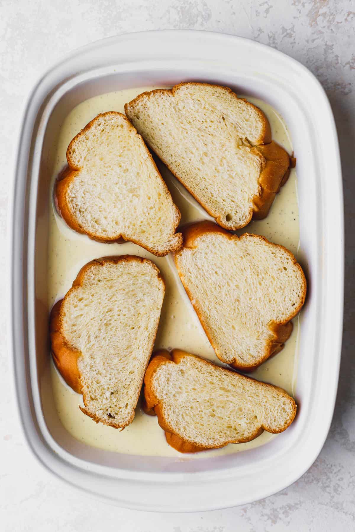 Sliced challah dipped in custard. 