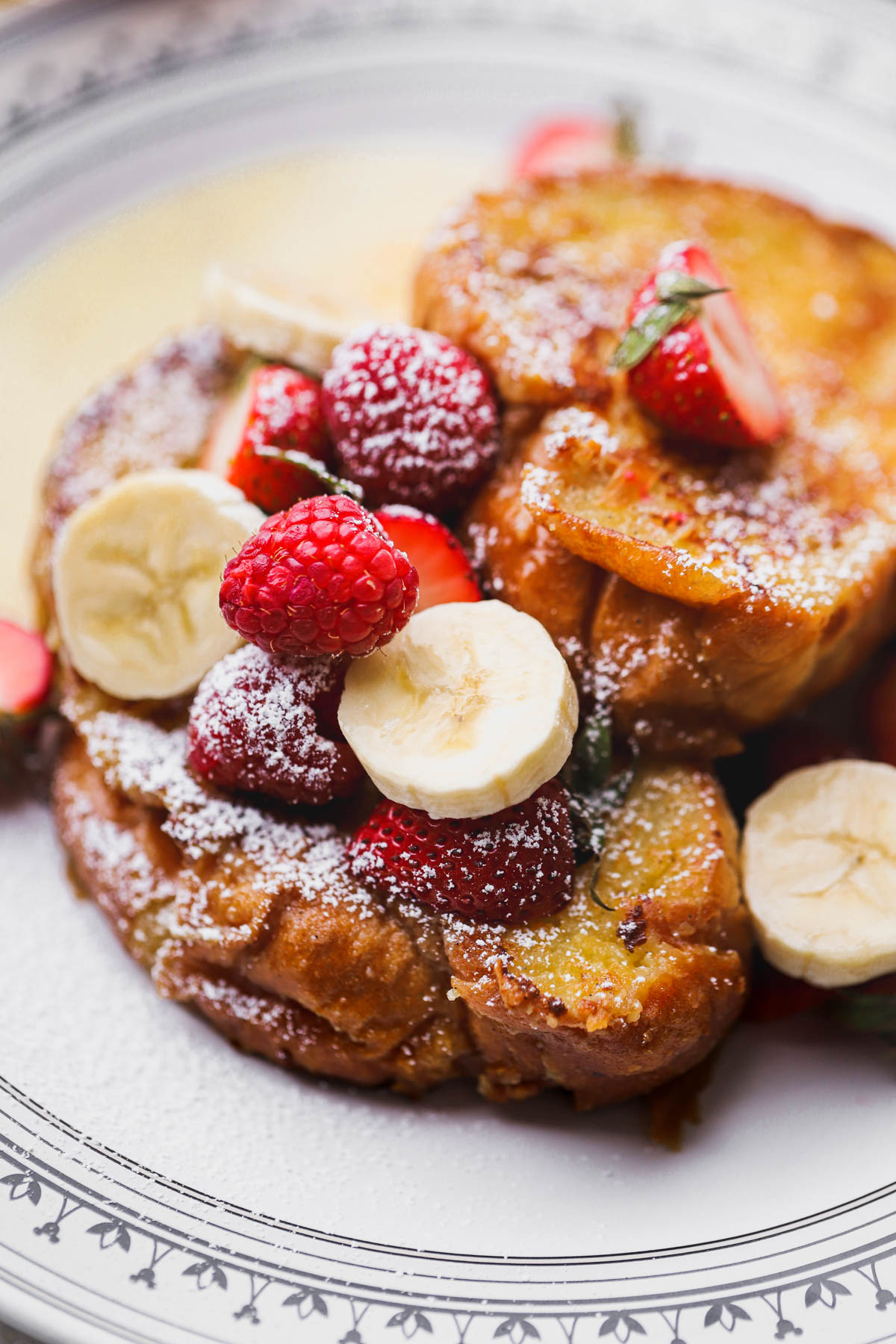 Custard French Toast cooked inside butter and topped with fresh berries and sliced bananas.