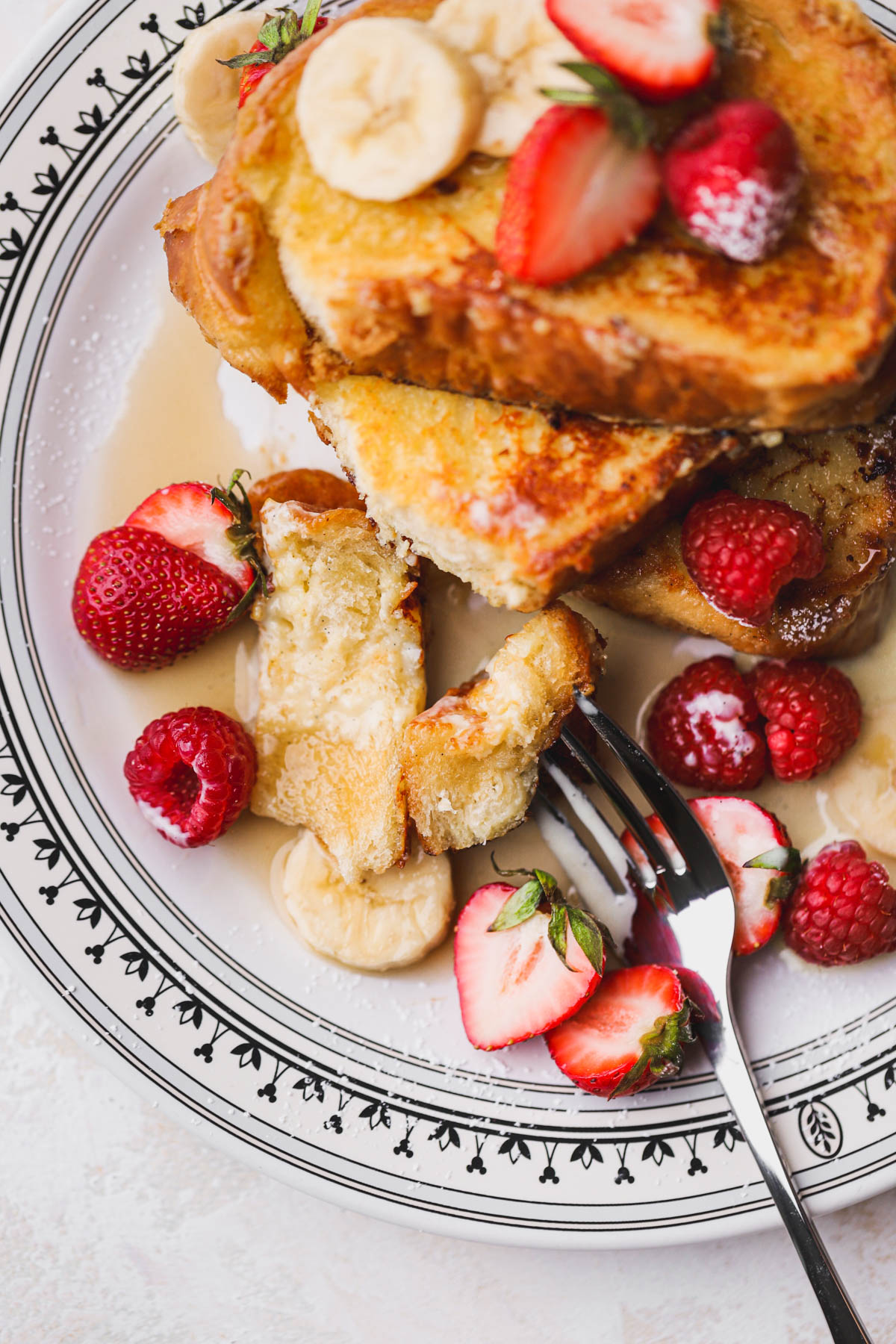 Custard French toast drizzled with maple syrup, vanilla custard and loads of berries. 
