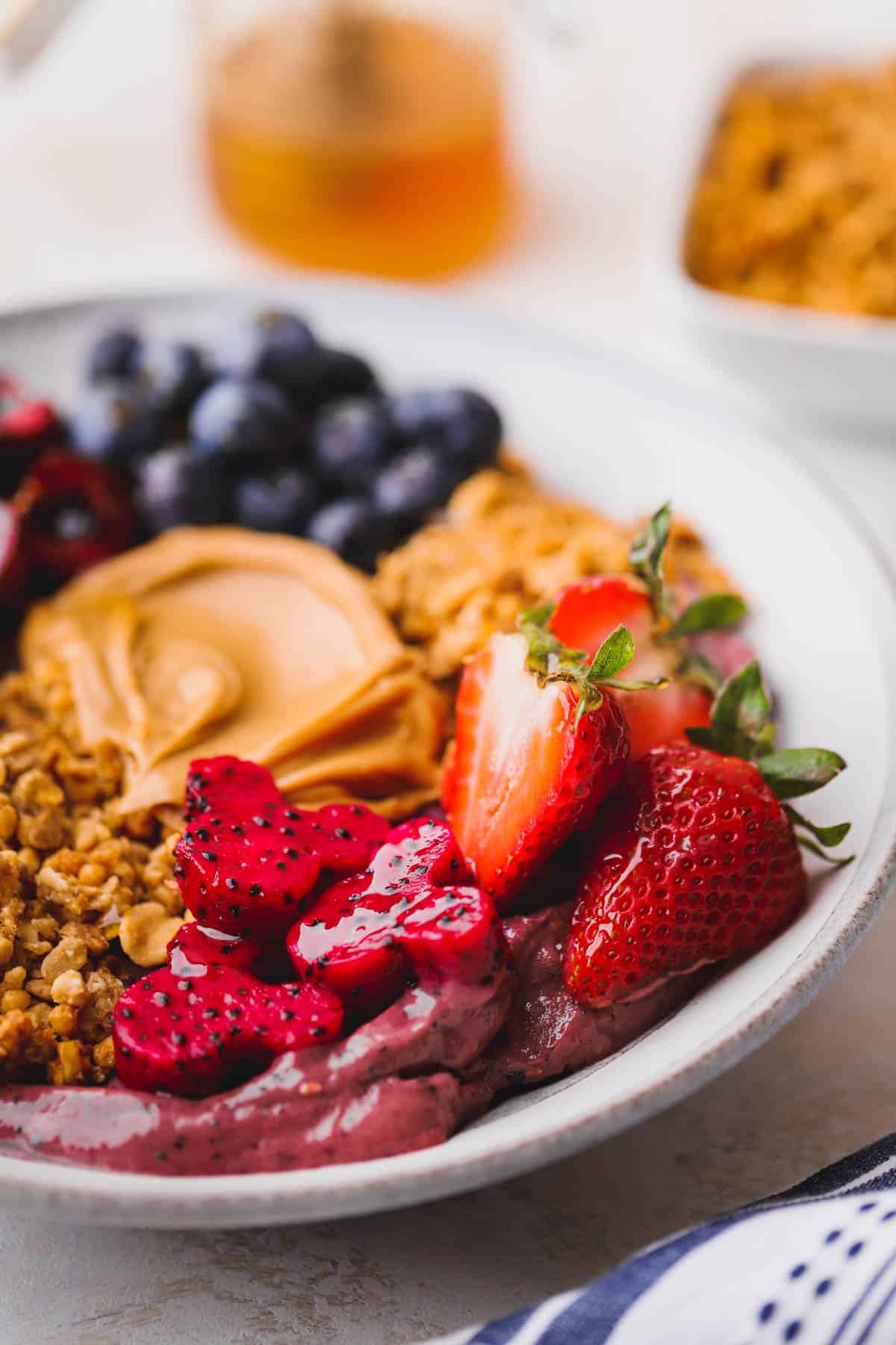 Dragon fruit, strawberries, granola and peanut butter spread.