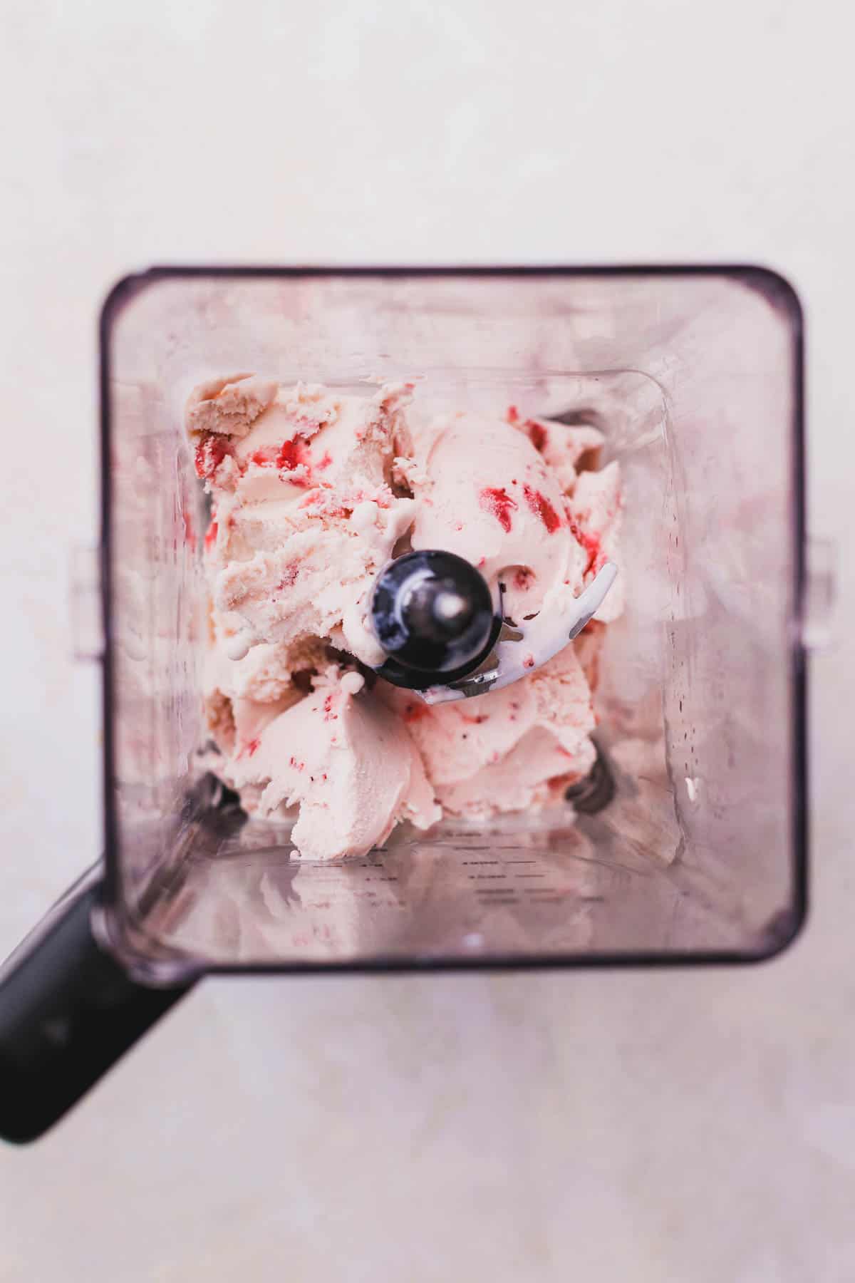 Strawberry ice cream inside blender.