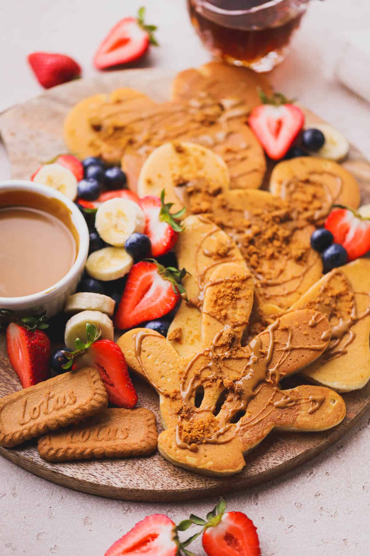 Mickey shaped pancakes with fresh fruit and syrup.