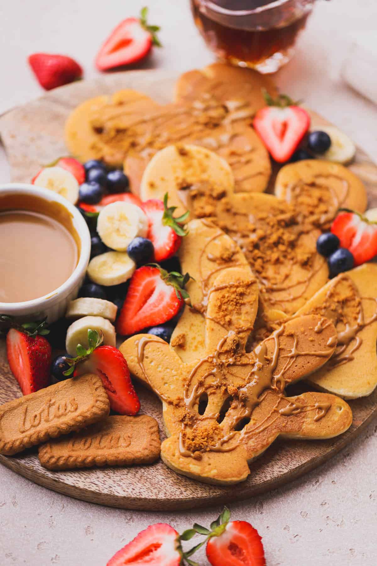 Mickey shaped pancakes with fresh fruit and syrup.  