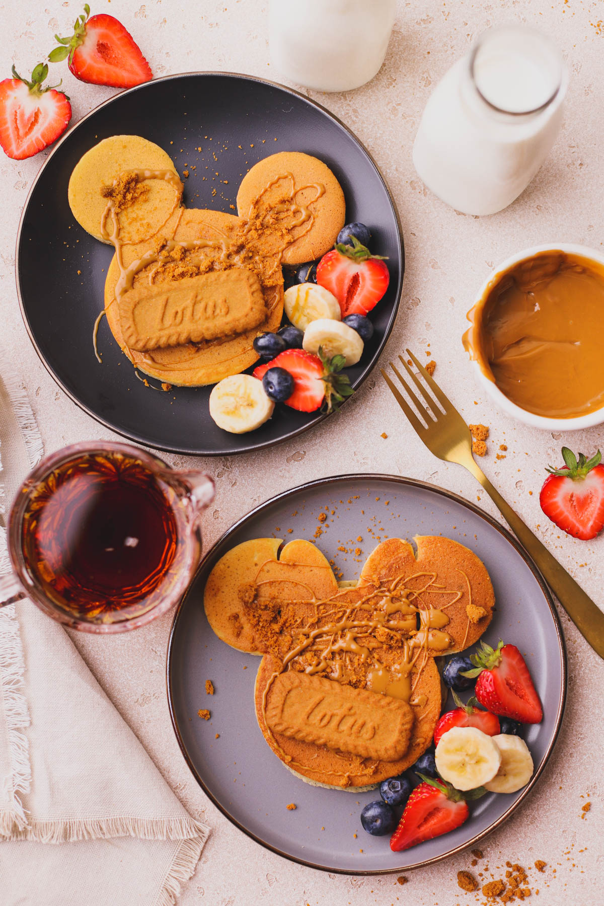 Cookie butter pancakes with fresh fruit and syrup.  