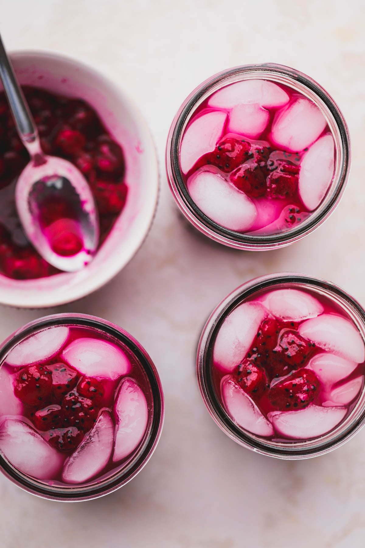 Dragon fruit lemonade topped with crushed dragon fruit and ice cubes.  