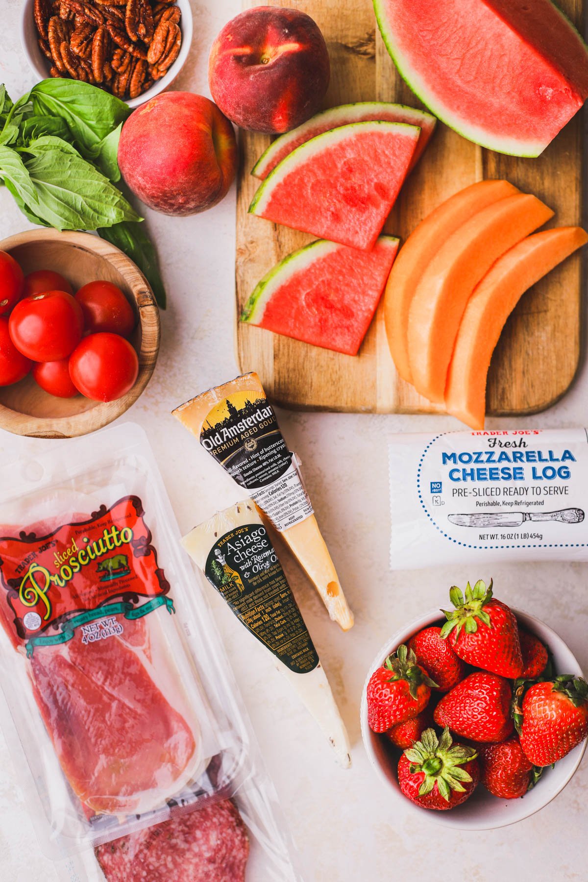 Prosciutto, gouda, cheddar, asiago, strawberries, mozzarella, tomatoes, basil, watermelon and berries.