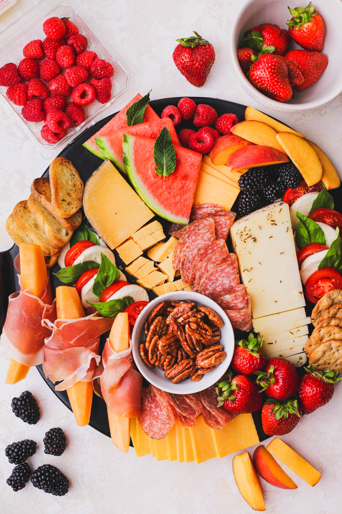 This summer charcuterie board is filled with delicious summer fruit, cheeses and meats.