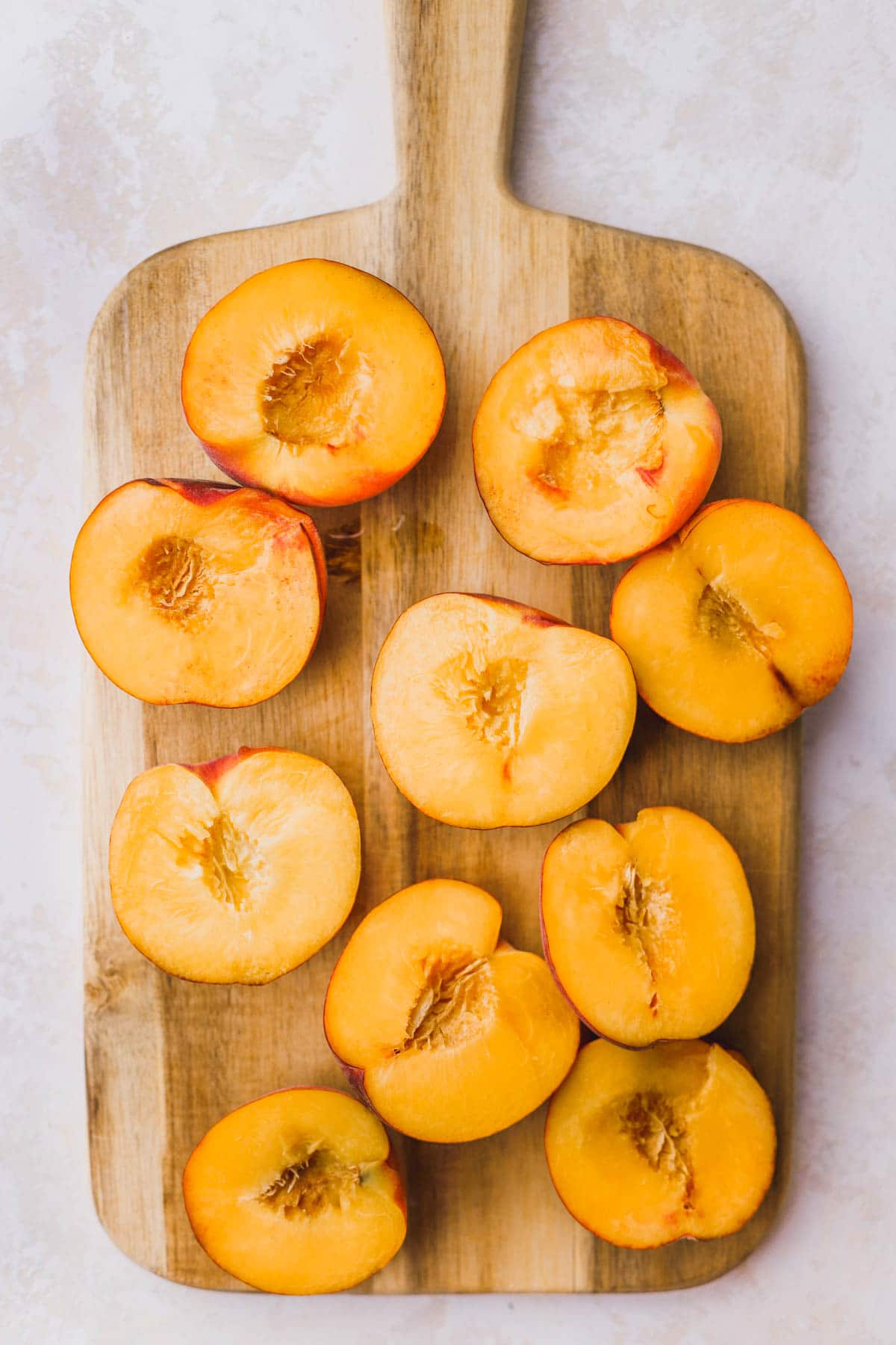 Fresh peaches cut in half and pitted.