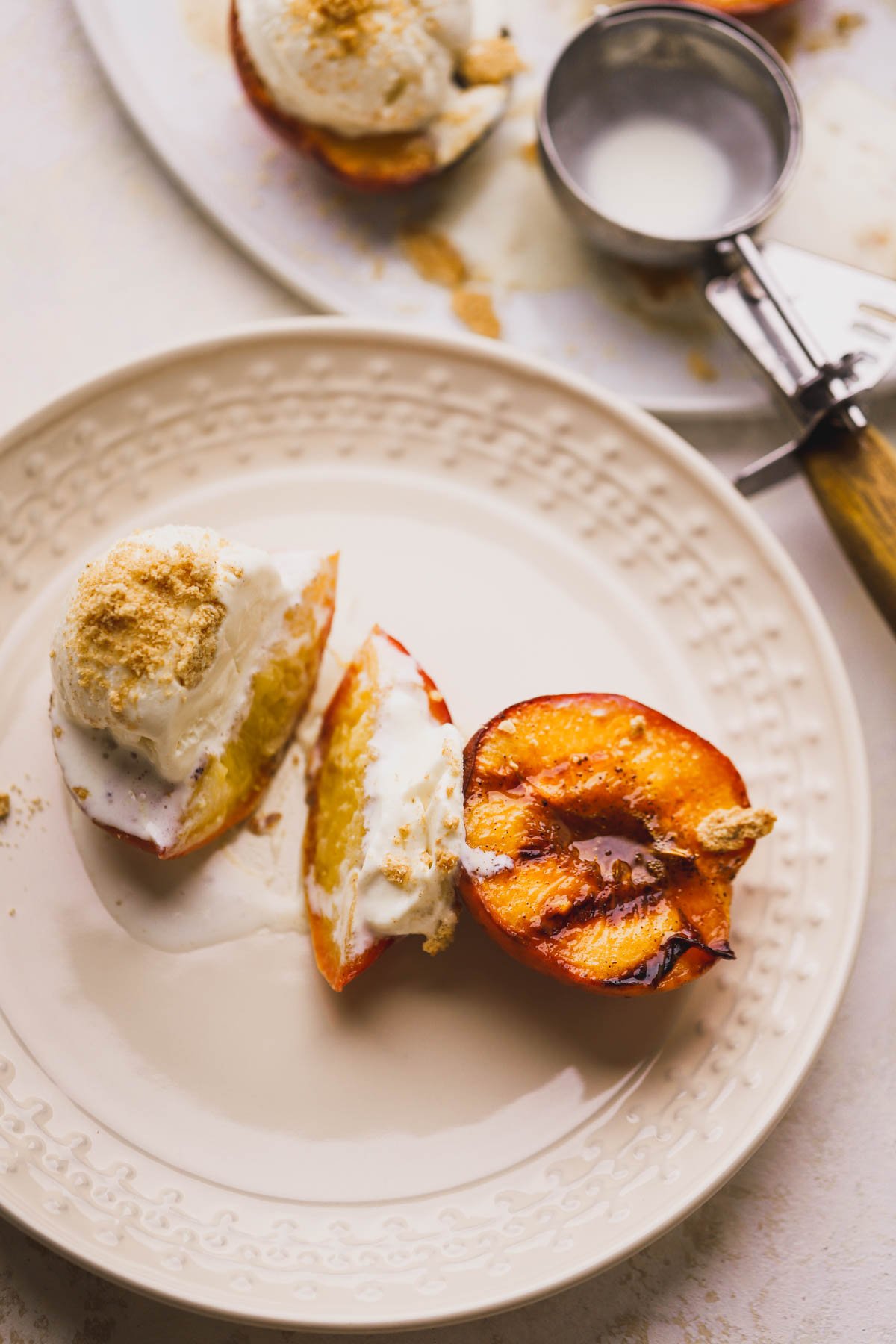 Grilled peaches with vanilla ice cream and Cinnamon Toast Crunch cereal.