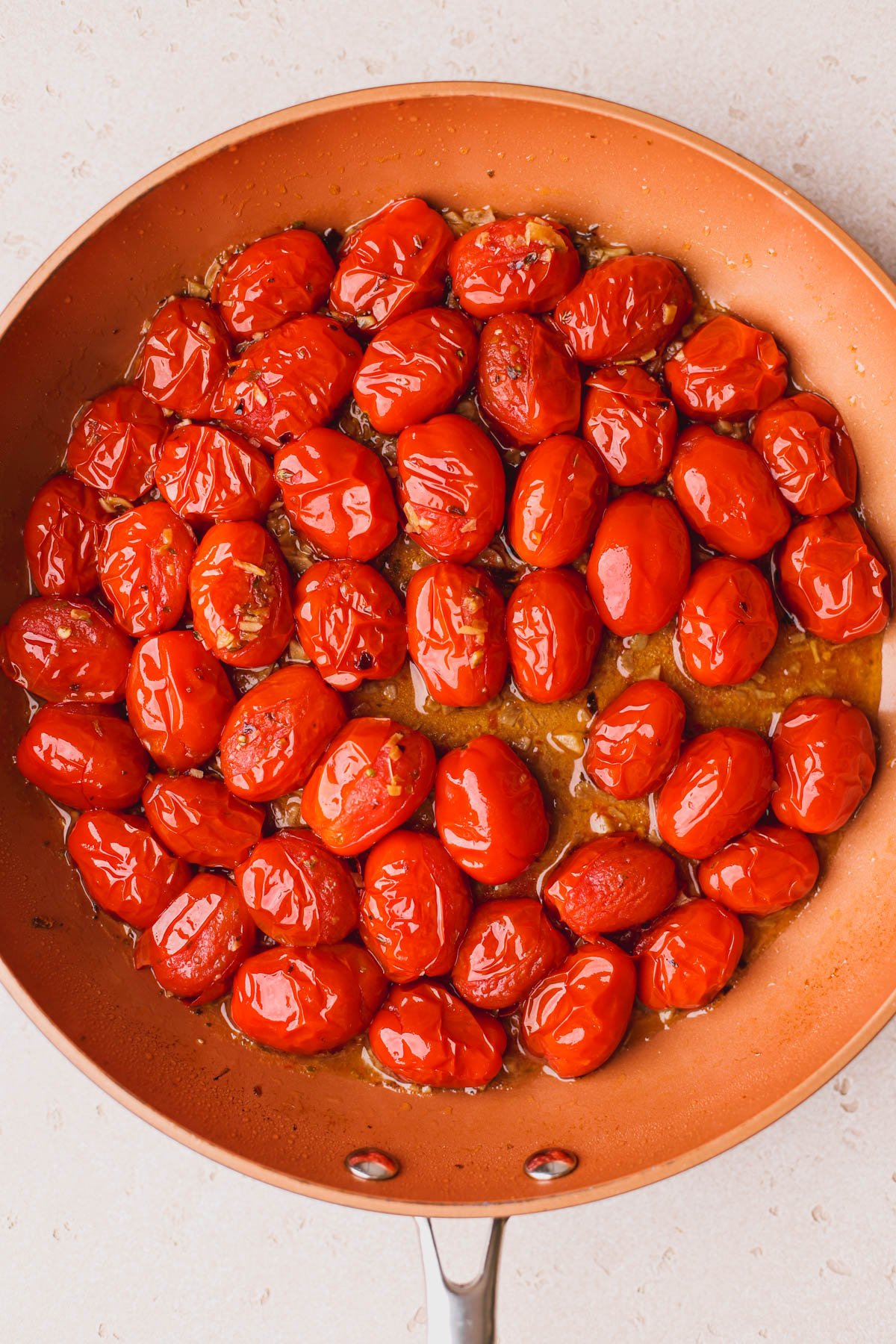 Cooked cherry tomatoes with garlic, oregano and red pepper flakes.