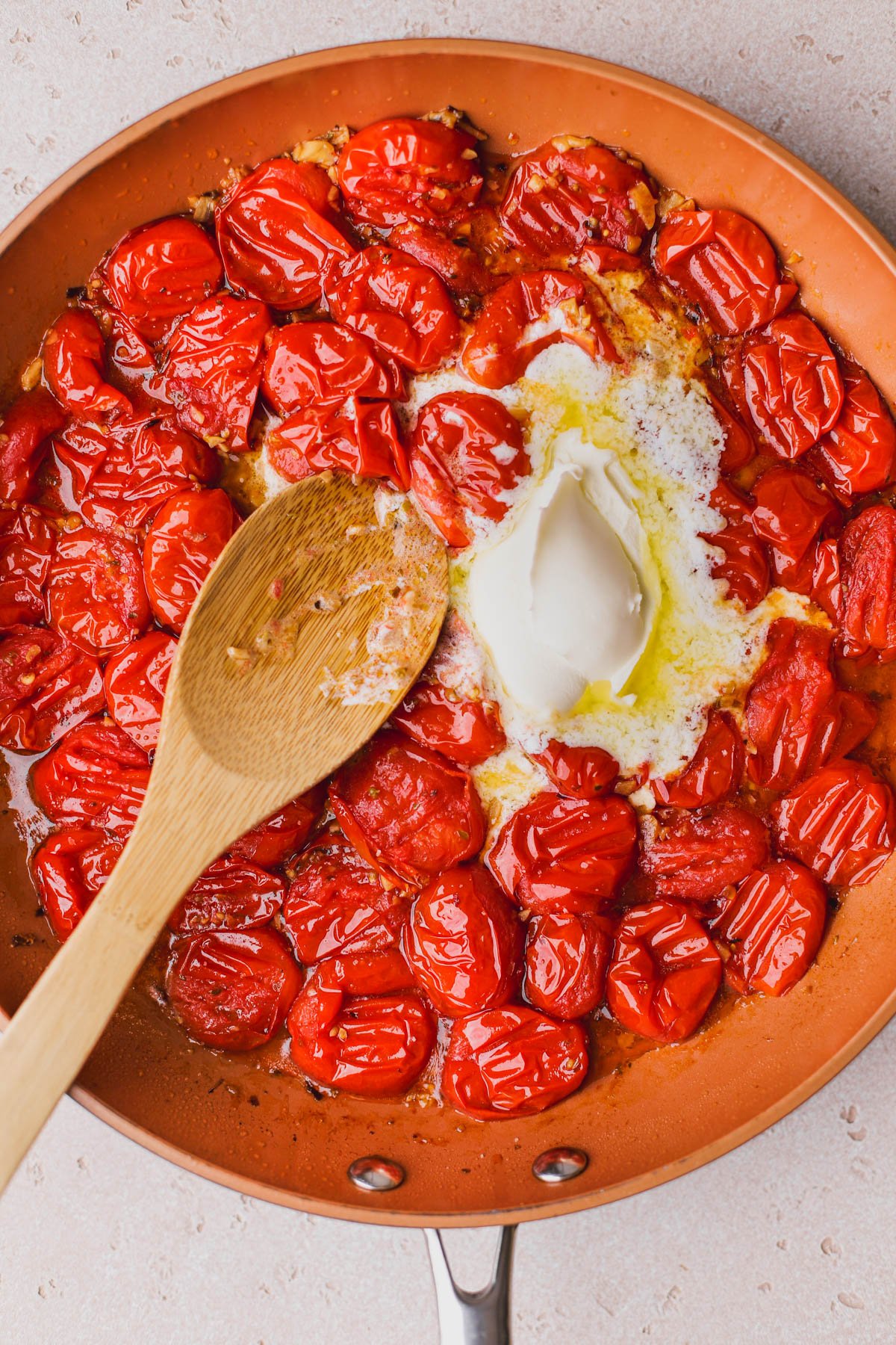 Smashed cherry tomatoes with melted mascarpone cheese.