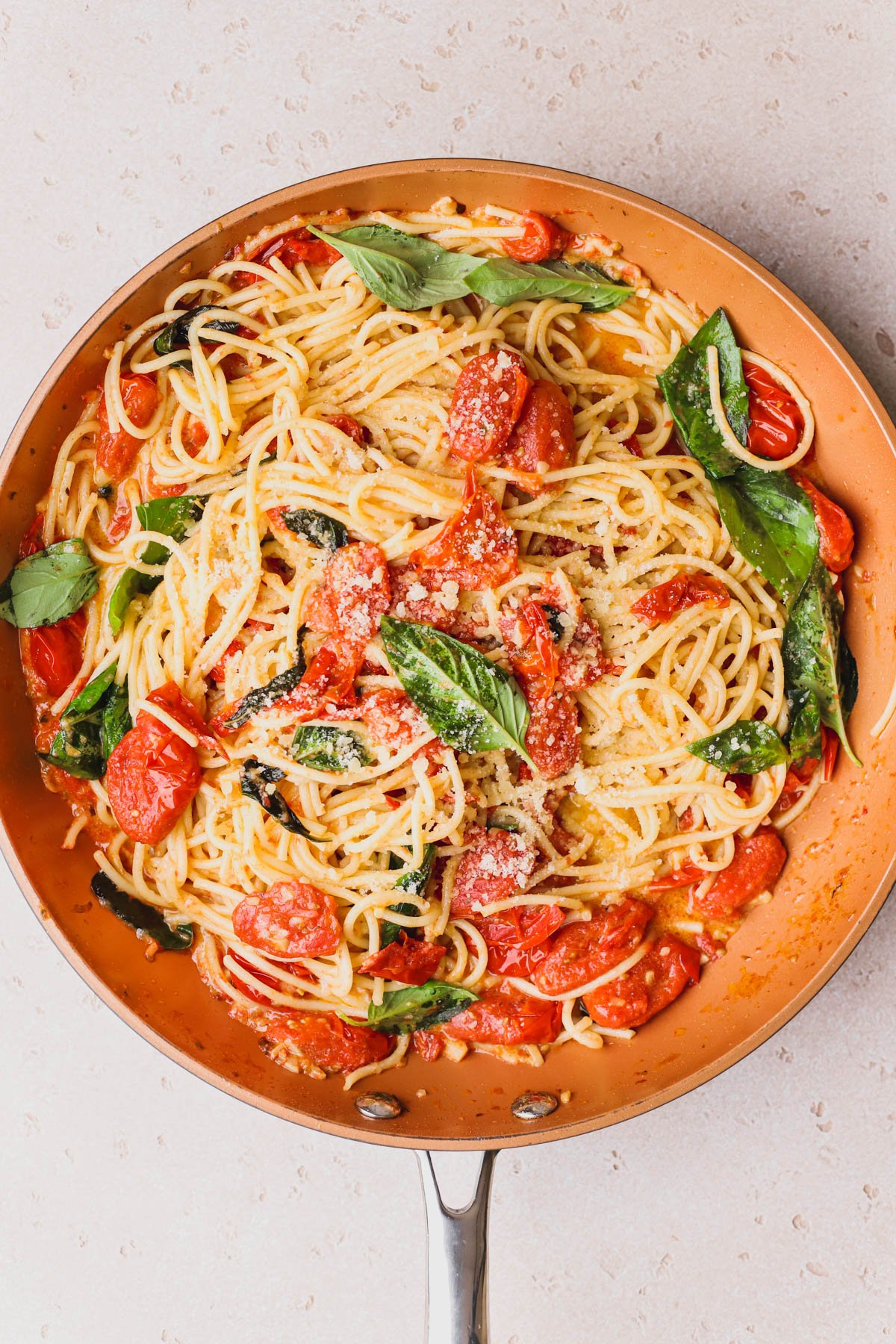 Cooked spaghetti tossed with cherry tomato sauce and mascarpone cheese.  Topped with fresh basil and parmesan cheese.  