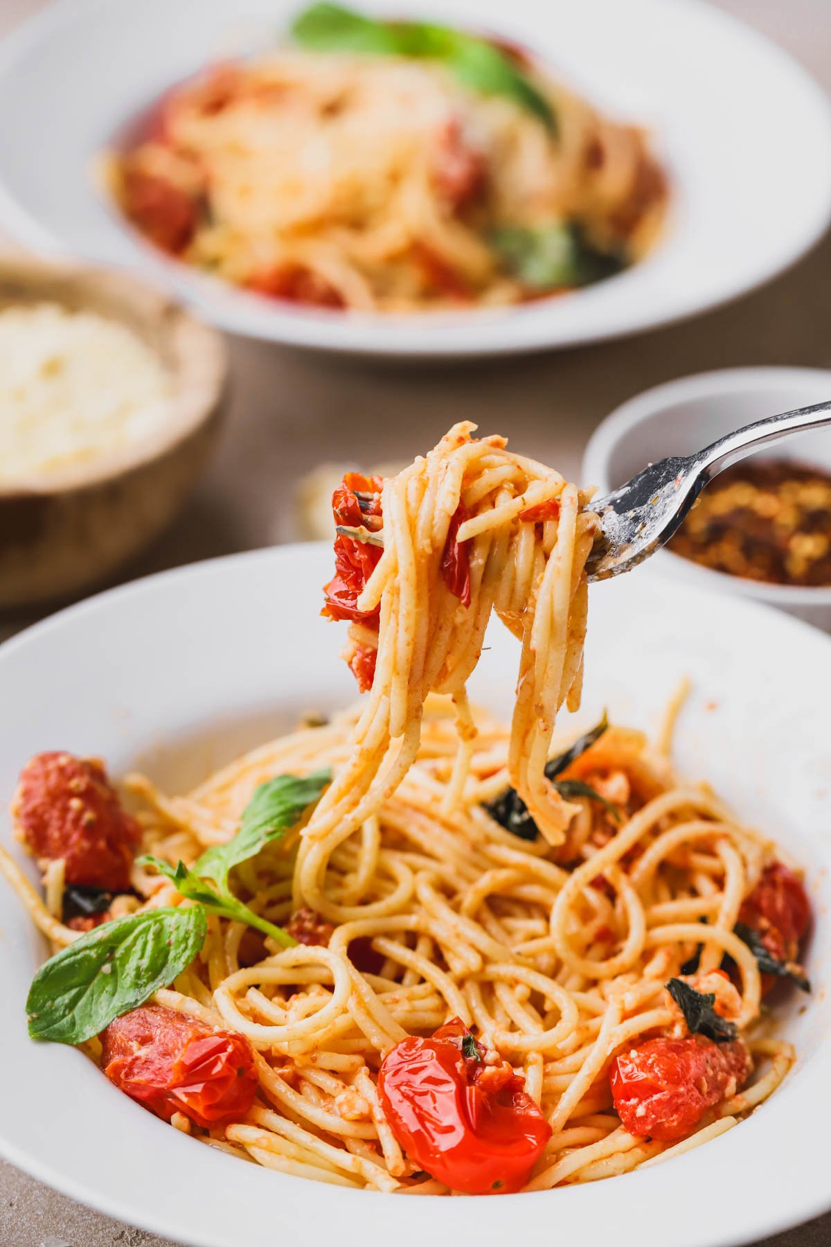 Spaghetti noodles with cooked cherry tomatoes, mascarpone, garlic, red pepper flakes and fresh basil.