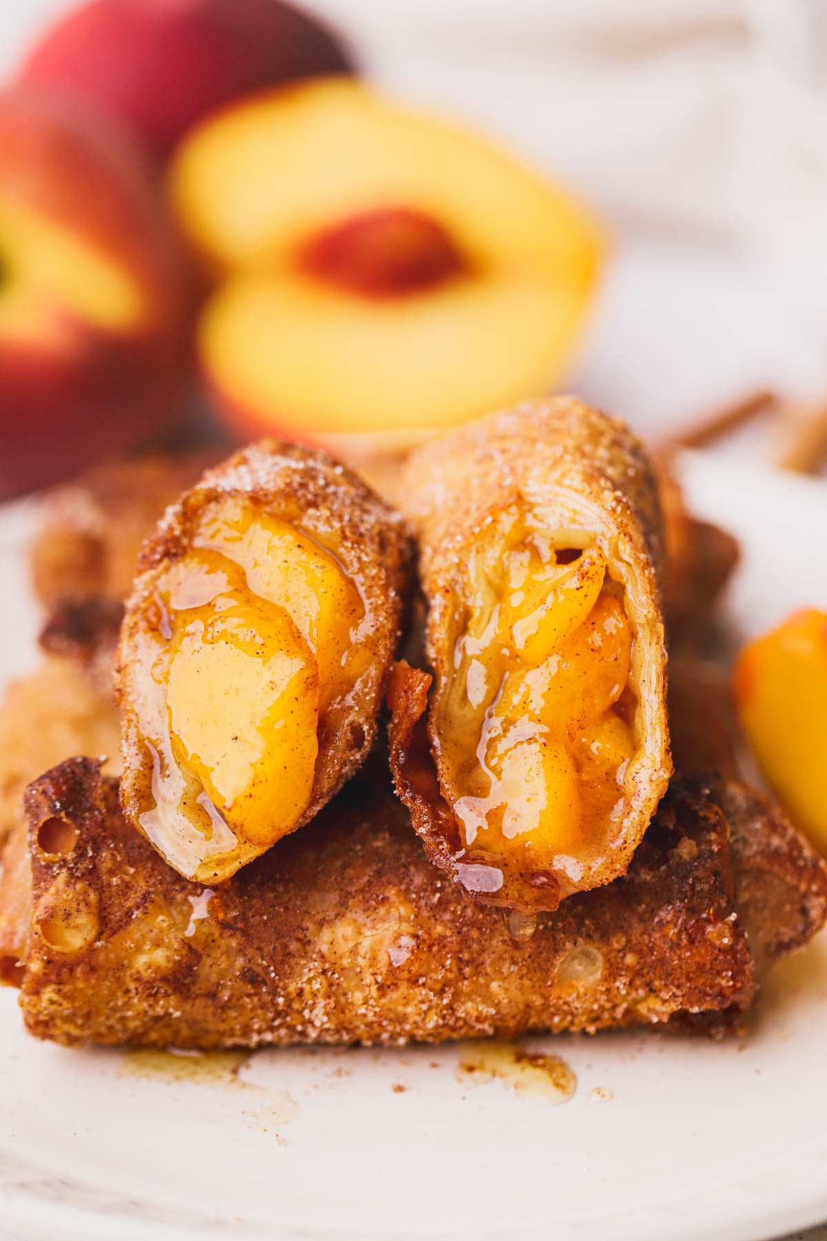 Crispy peach cobbler egg rolls filled with fresh peaches, warm spices and brown sugar.