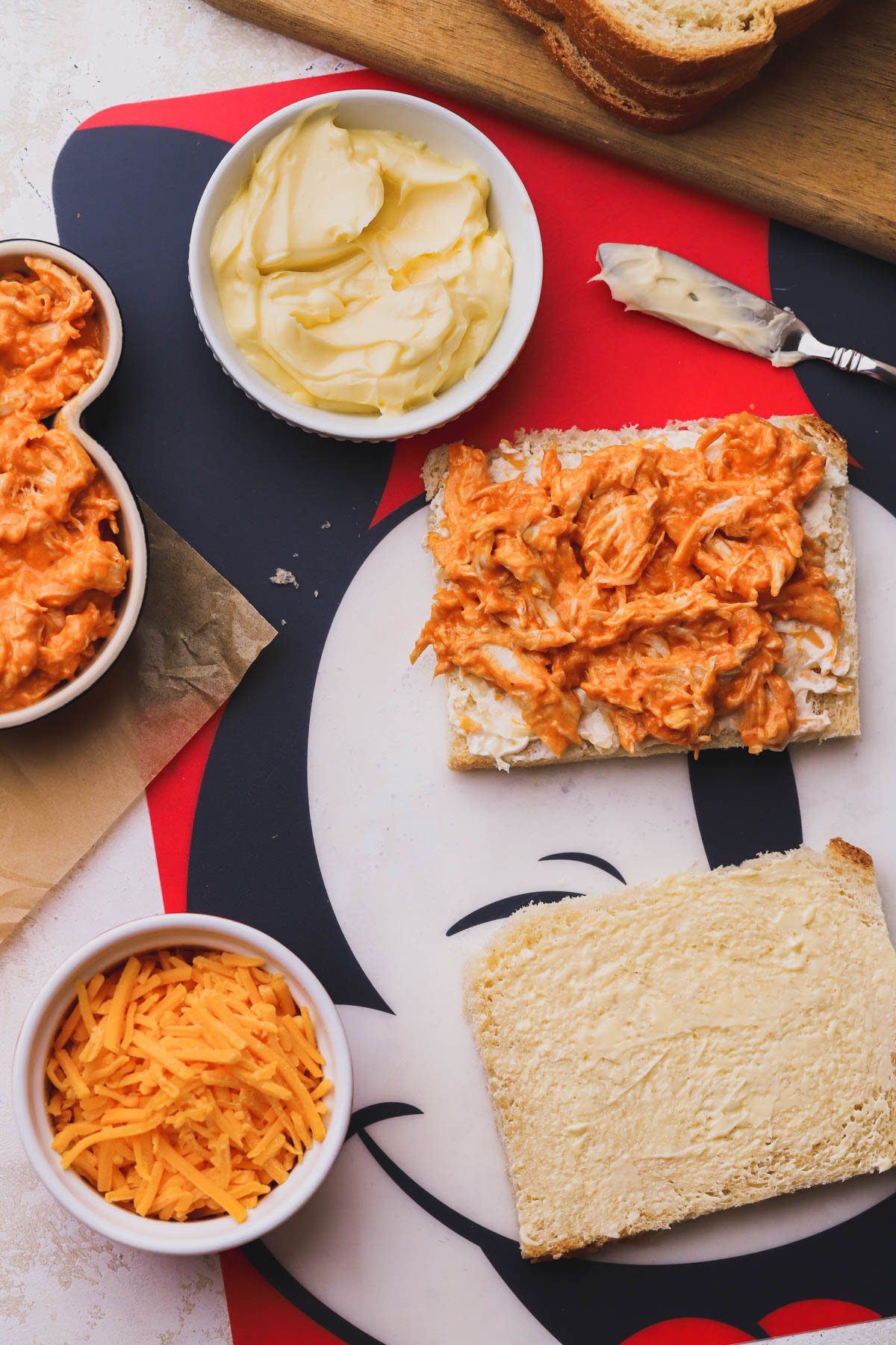 Sliced bread coated with mayo-butter mixture and filled with spicy chicken and three cheese spread.
