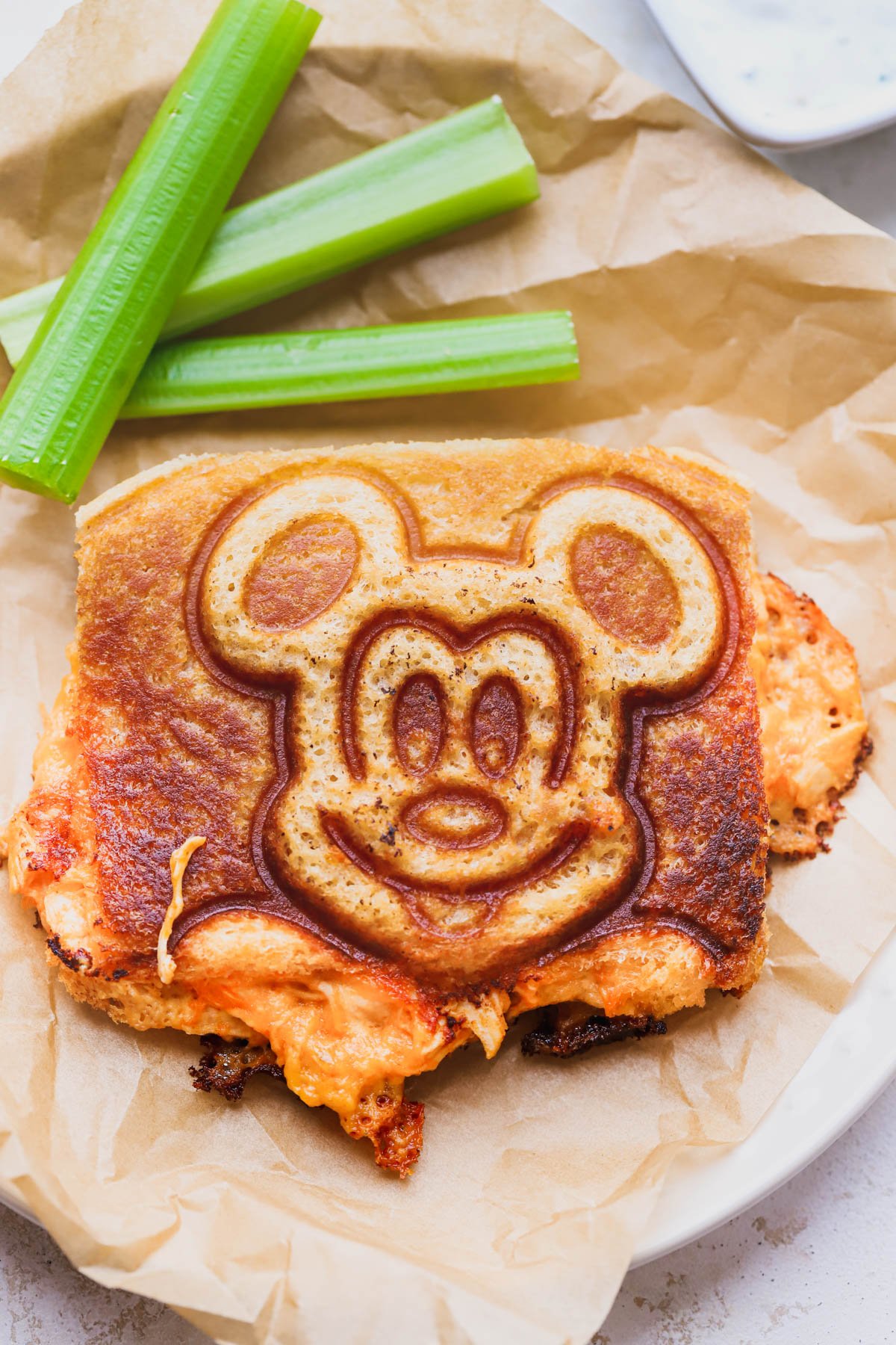 Buffalo chicken grilled cheese sandwich with clergy sticks and blue cheese dressing.