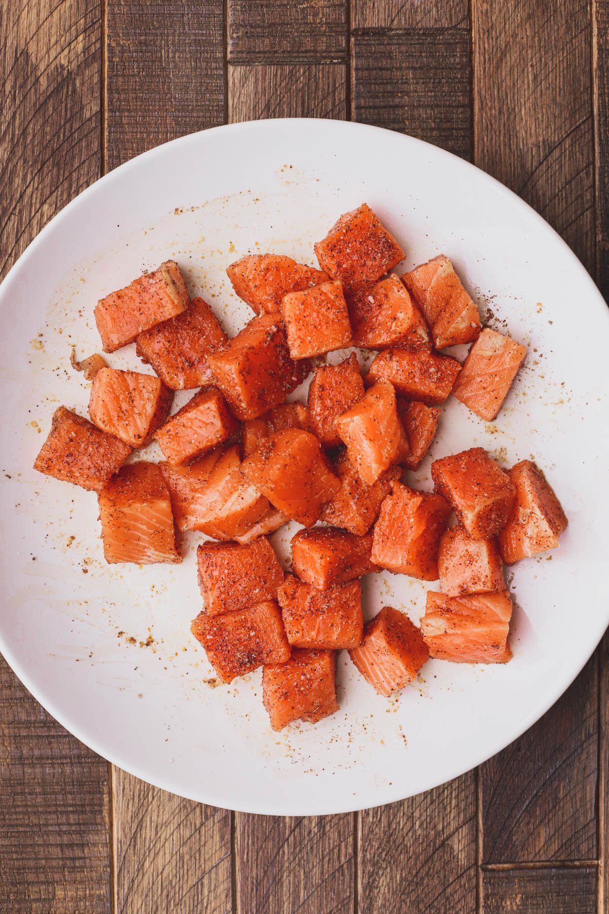 Chunks of salmon mixed with seasoning.