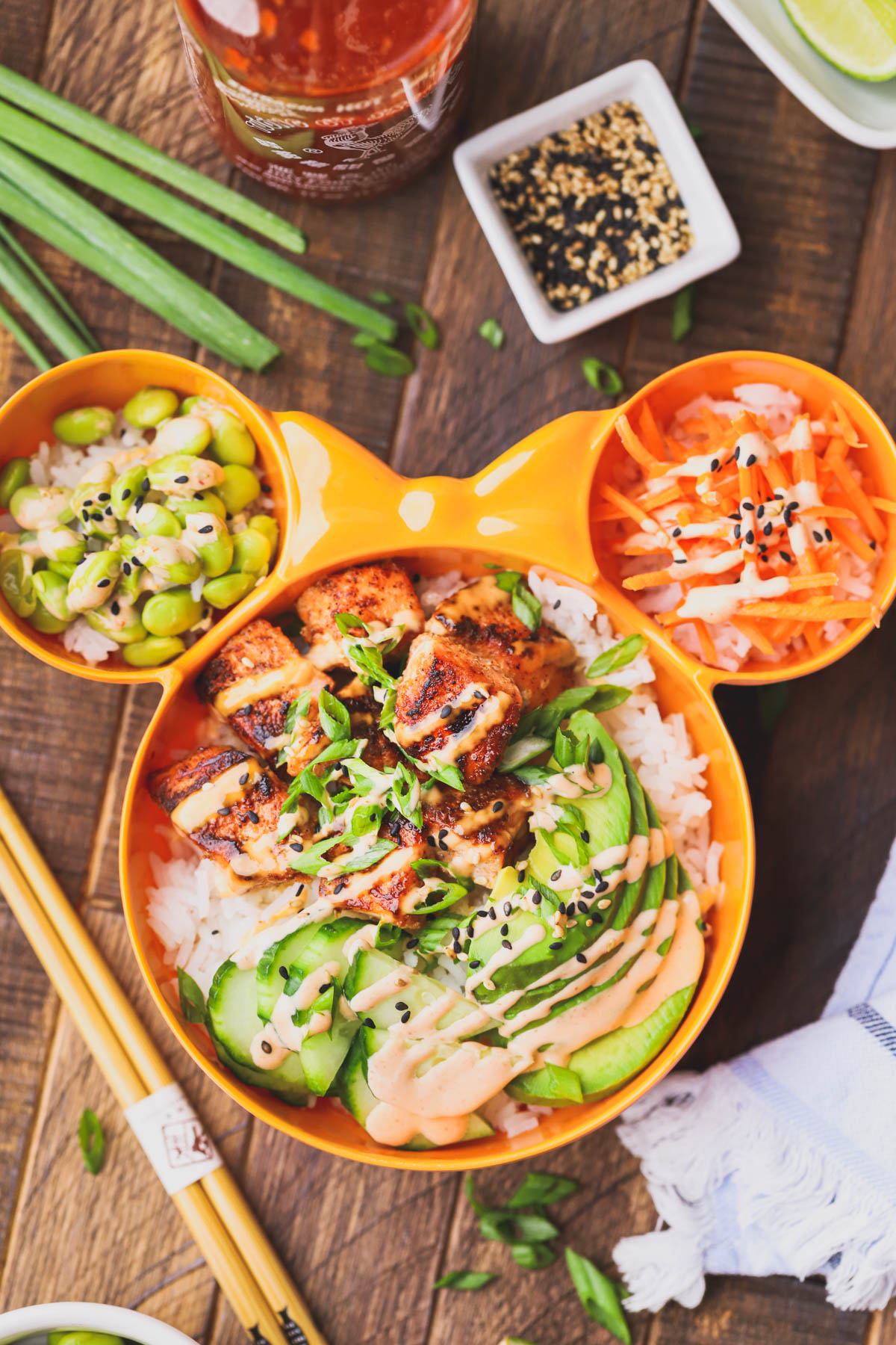 Spicy salmon bowl filled with seasoned salmon, rice, crunchy veggies and spicy mayo.