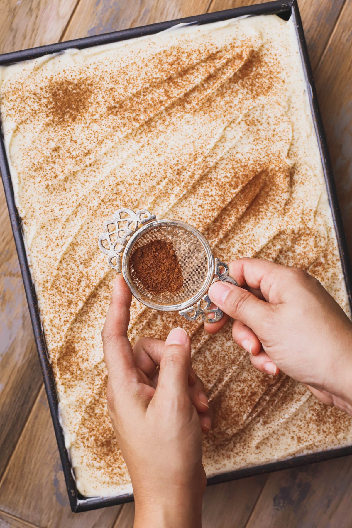 Pumpkin bread with cream cheese frosting dusted with cinnamon.  