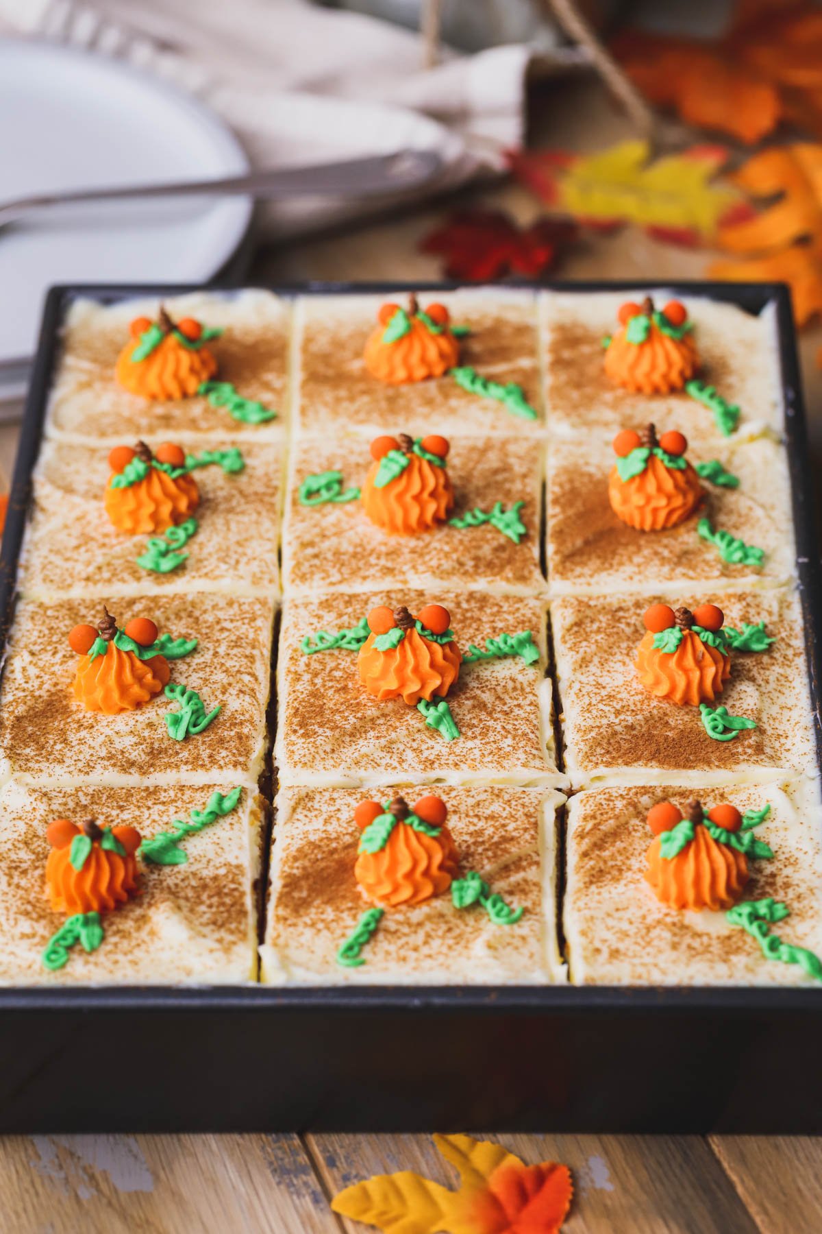 Pumpkin bread with cream cheese frosting decorated with Mickey pumpkins.