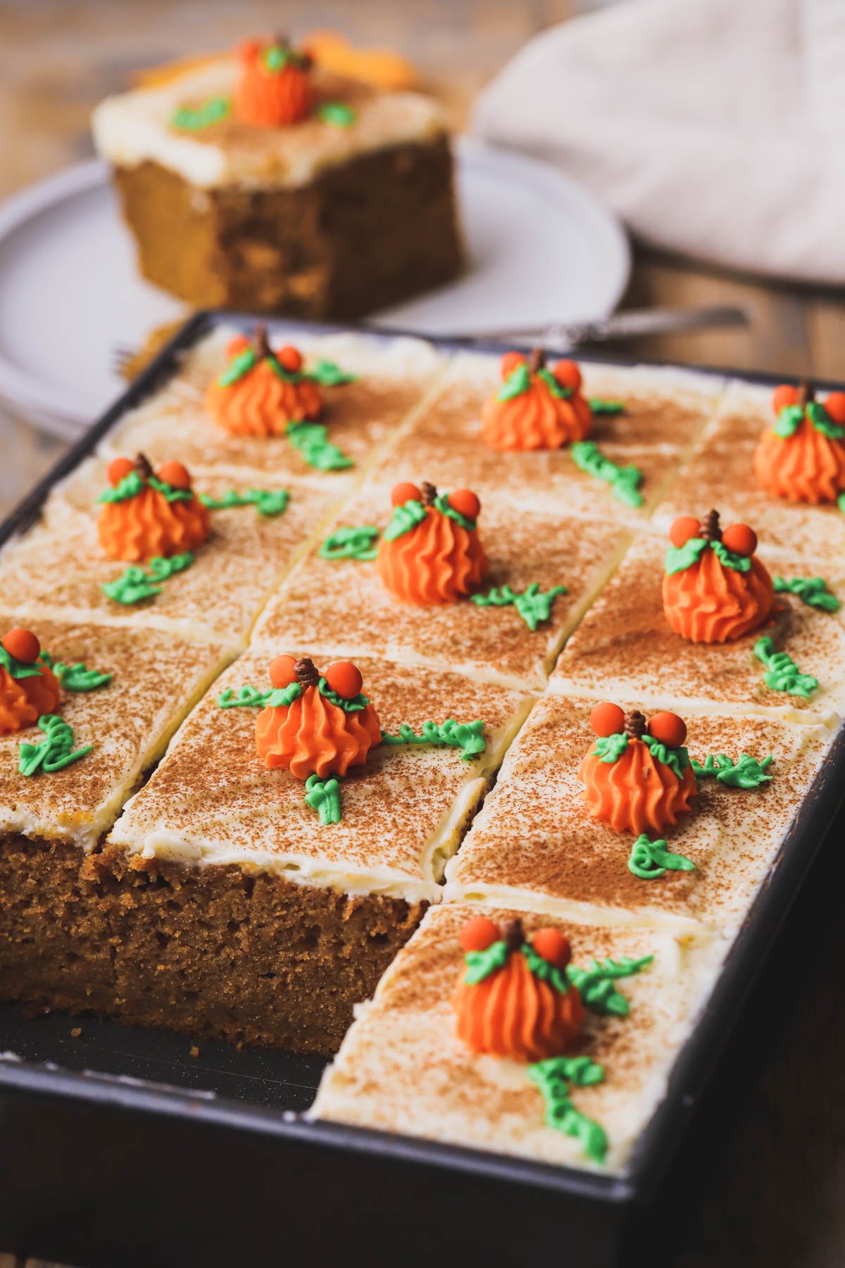 Thick slices of pumpkin bread with cream cheese frosting. Piped Mickey buttercream pumpkins on top.
