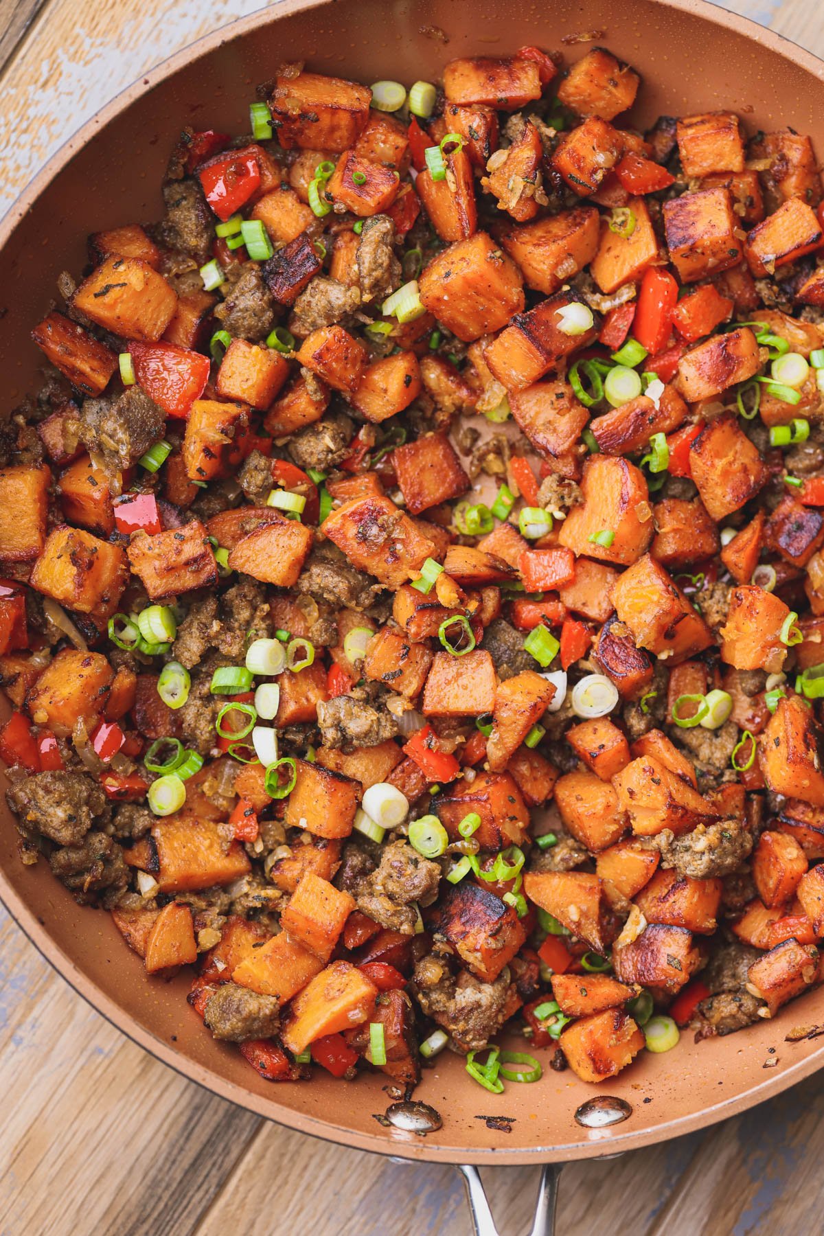 Sweet potato hash with sausage, sage, smoked paprika, garlic and green onions.  