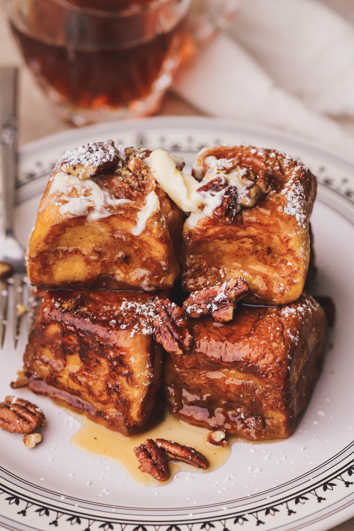 Hawaiian bread French toast drizzled with warm maple syrup, candied pecans and butter.  