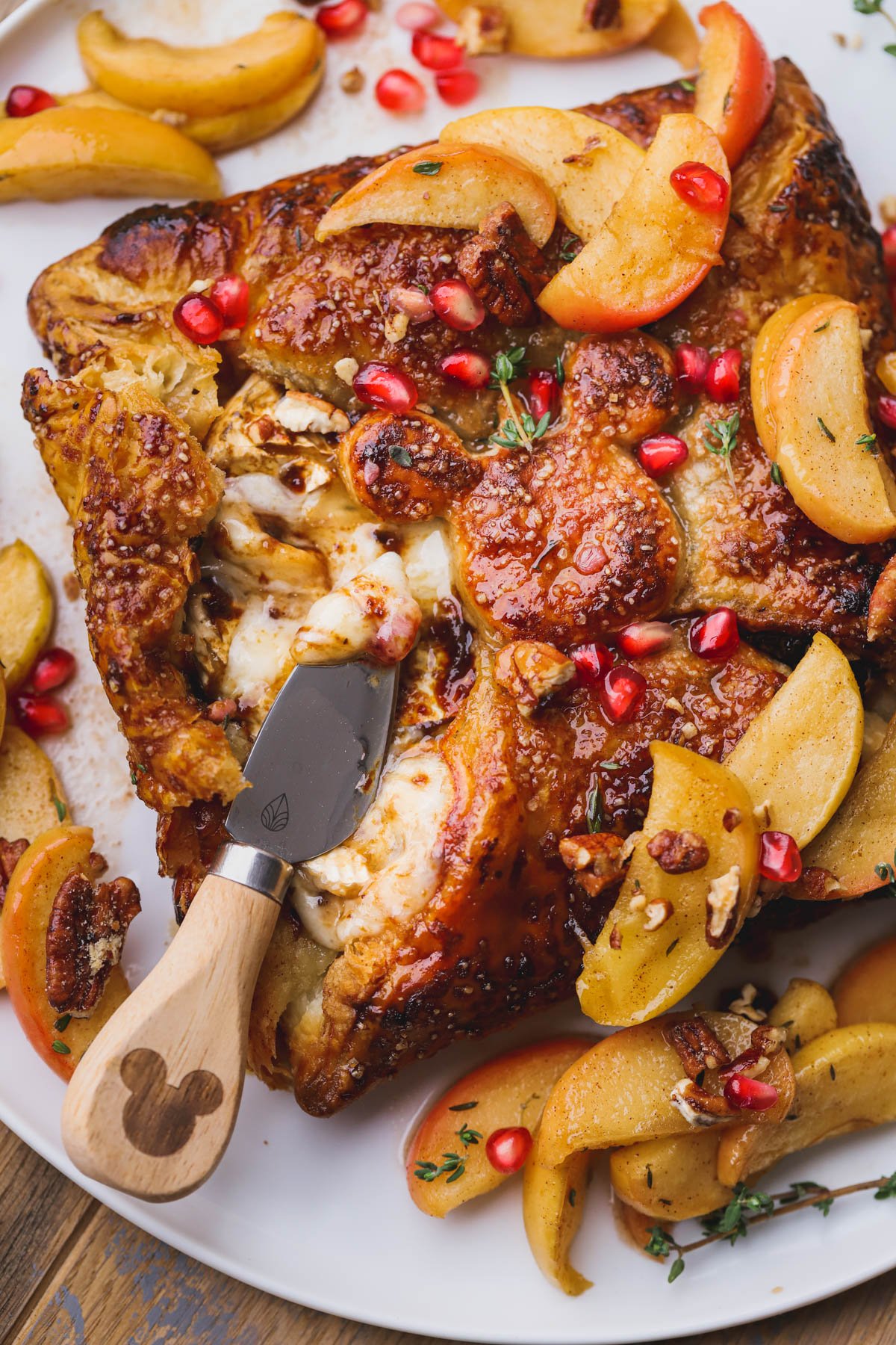 Baked brie with fig jam topped with roasted apples, pomegranates and pecans.  