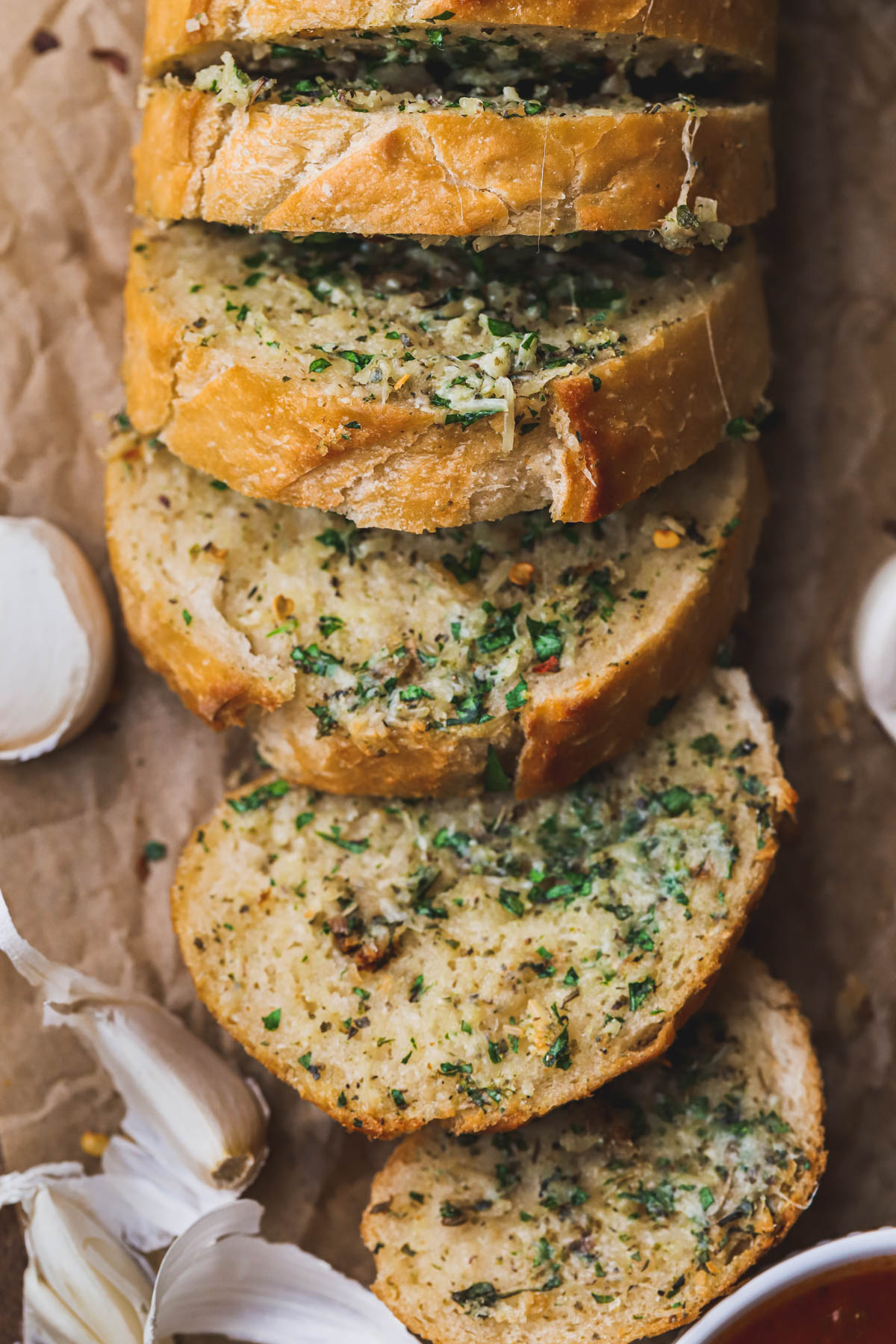 Baked sourdough bread with garlic herb butter spread.  