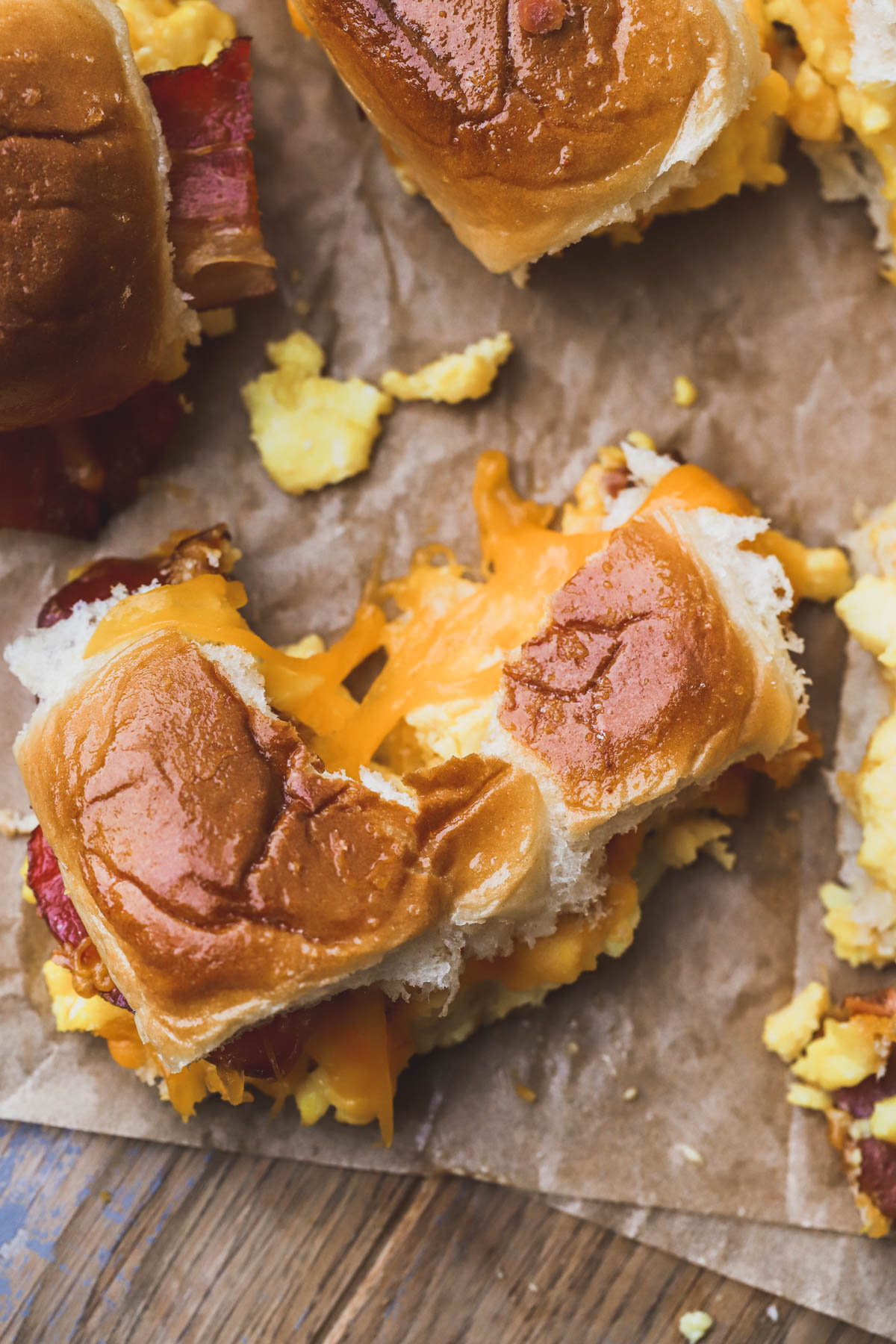 Hawaiian roll breakfast sliders with melted cheddar cheese, eggs and bacon.  