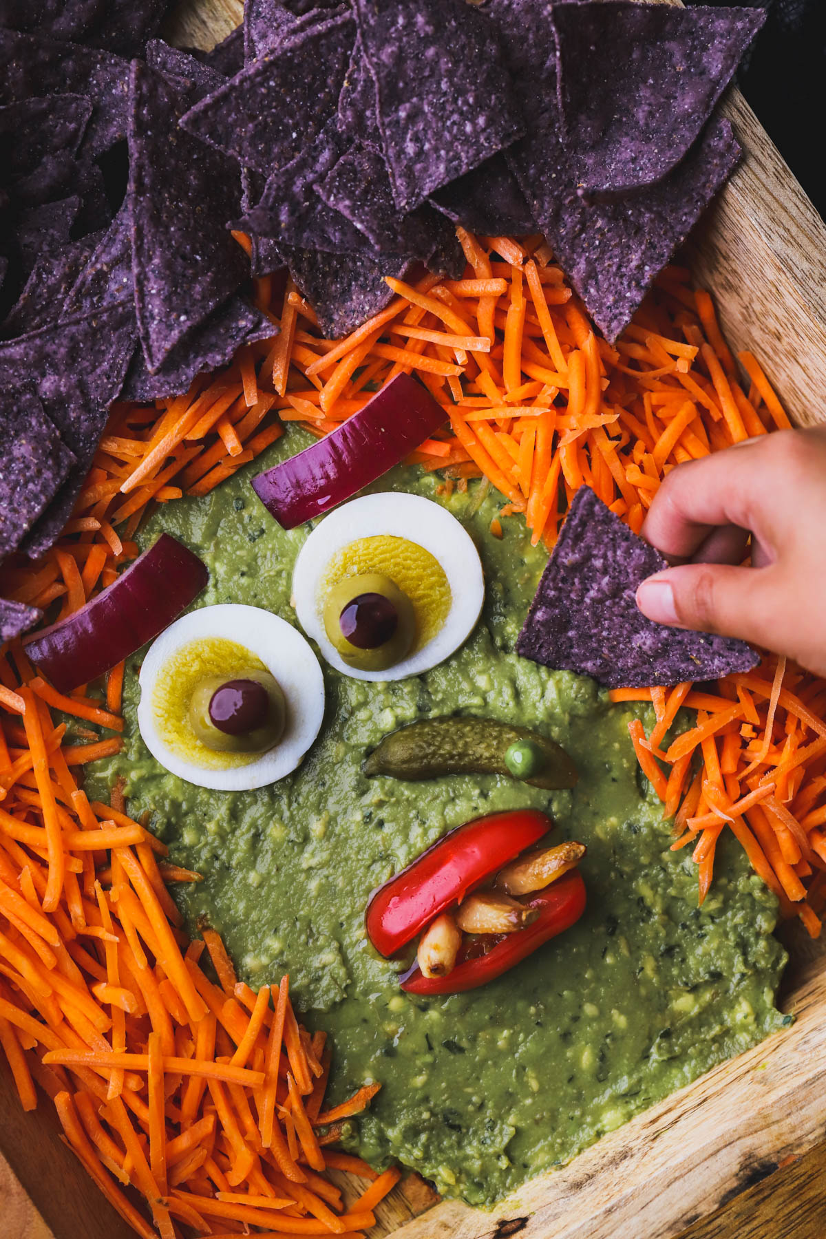 4 ingredient guacamole shaped into a spooky witches face.  