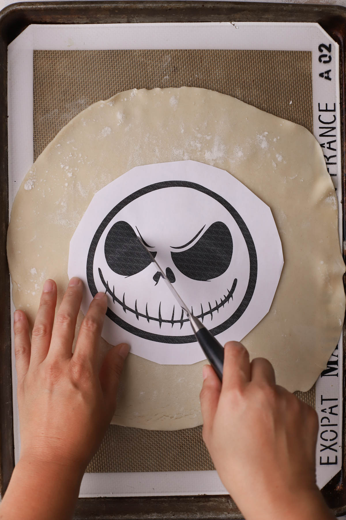 Jack skellington template on top of rolled pie dough.  