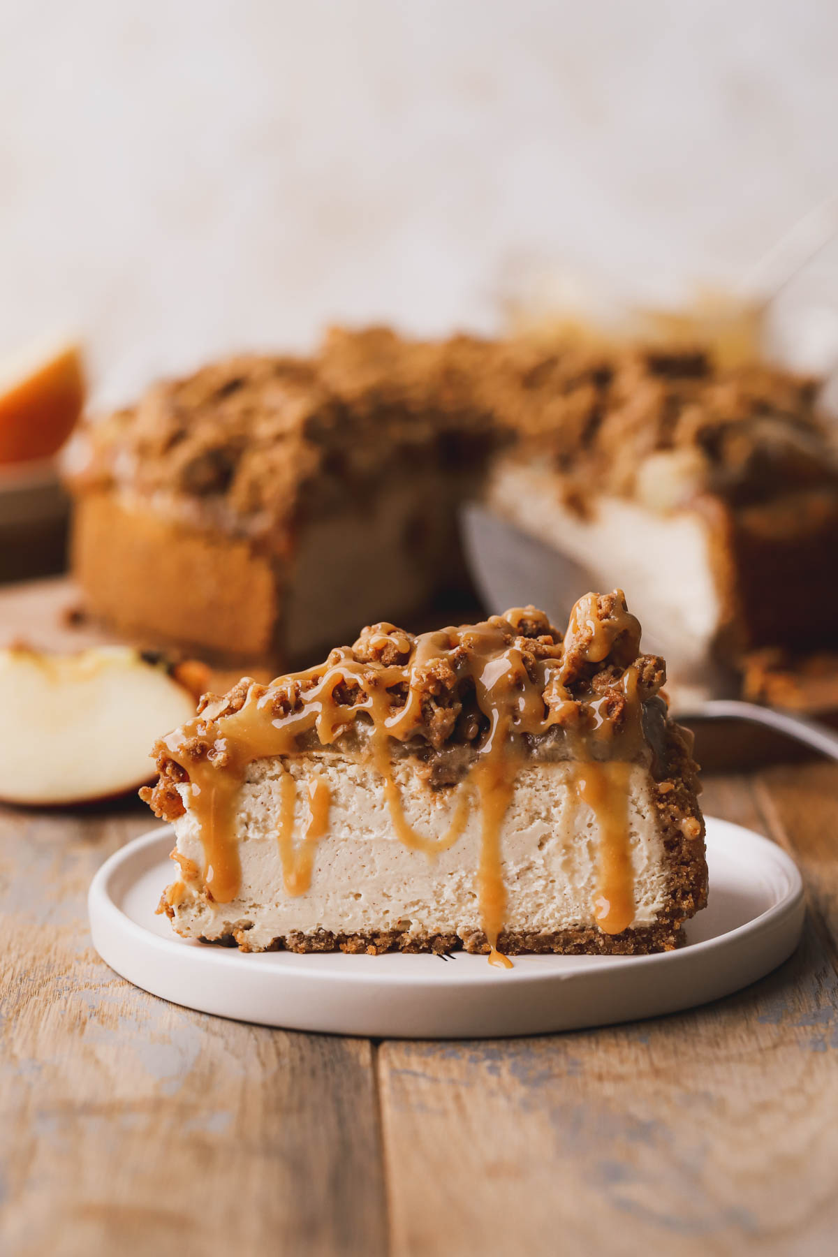 Sliced apple crumble cheesecake, topped with apple pie filling, crispy crumble and drizzled with caramel sauce.  